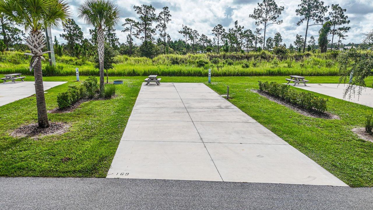 Discover a rare opportunity to own in Resort at Canopy Oaks — one of Central Florida’s premier luxury RV resorts. This deeded 45’ x 90’ RV Lot 169 offers privacy, convenience, and income potential in one exceptional package.

Ideally positioned at the rear of the resort, Lot 169 provides the best of both worlds — added privacy while still enjoying easy access to the bathhouse and laundry facilities. The spacious 20’ x 70’ concrete pad with full 20/30/50 amp hookups easily accommodates Class A and Class C motorhomes, fifth wheels, travel trailers, or a small park model — ready for immediate enjoyment and customization to your preferences.

Ownership includes access to 435 acres of gated resort luxury, featuring a tropical tiki bar with live music, resort-style pool and hot tub, pickleball courts, fitness center, full-service spa, and on-site dining. Enjoy it as your personal retreat or participate in the professionally managed rental program to generate income while you’re away.

RV lots in this sought-after community are limited. With developer incentives currently available, now is the time to secure your place in this exceptional resort. Schedule your private tour today before this opportunity is gone.