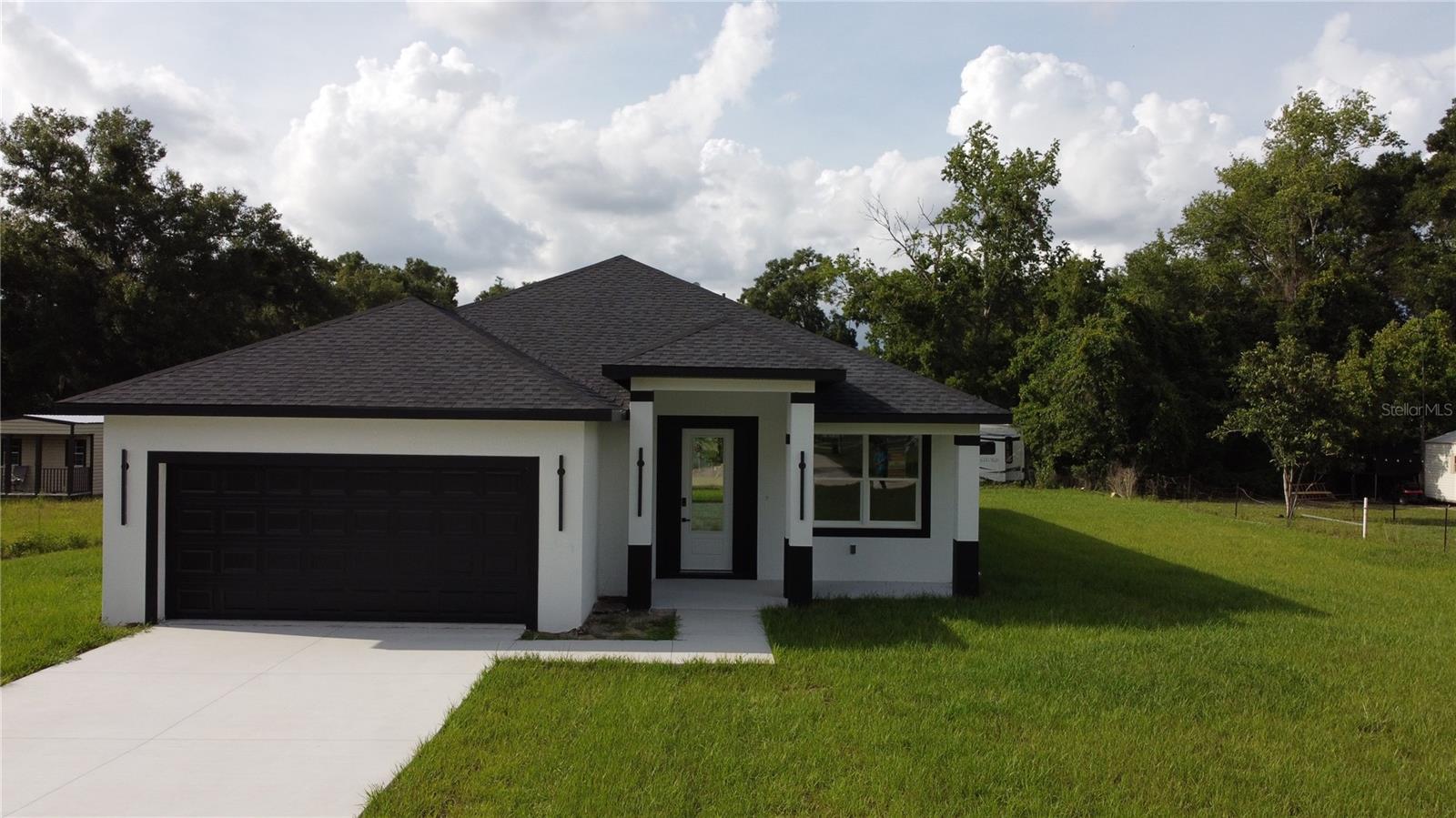 Welcome to this brand-new 2026 construction home in Summerfield, offering 4 bedrooms, 2 bathrooms, 1,850 heated sq ft, and 2,612 total sq ft. This thoughtfully designed home features an open floor plan, vinyl plank flooring, ceiling fans, and elegant 9-ft tray ceilings in the primary bedroom and living room. Nestled on a spacious 0.32-acre lot with no HOA, the home is surrounded by beautiful horse farms, offering a peaceful and serene country setting. Enjoy the best of quiet living while remaining close to everyday conveniences, including local convenience stores. FHA, Conventional, USDA, and VA financing available. A wonderful opportunity to own new construction in the heart of Marion County!