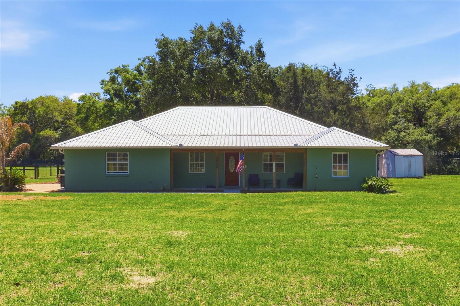 Move-In Ready 3BR/2BA Home on 2.75 Acres in SE Marion County!  MOTIVATED SELLERS!!

Nestled in a serene country setting, this charming 3-bedroom, 2-bathroom home with a bonus office is the perfect retreat for those seeking space, tranquility, and convenience. Situated on 2.75 high and dry fenced acres, this property is ideal for families and animal lovers alike. Built in 2000 and lovingly maintained, it offers the best of both worlds: peaceful rural living just minutes from HWY 441, I-75, Belleview, and The Villages. A NEW Metal Roof was installed in 2021.

Step onto the inviting front porch—perfect for rocking chairs and morning coffee—and into a thoughtfully designed interior. The split floor plan provides privacy, while the vaulted ceilings, warm paint tones, and a mix of vinyl and tile flooring add a welcoming touch throughout. This home is designed for both relaxation and functionality, blending northern and southern exposures to maximize natural light.

The formal dining room, along with a cozy breakfast nook, gives you plenty of options for entertaining or casual meals. The kitchen is a true standout, featuring stainless steel appliances, a stylish tile backsplash, and plenty of space for meal prep. The master suite is a relaxing haven, complete with a spacious walk-in closet and an updated ensuite bath showcasing a high-end double vanity, separate shower, and space to add a soaking tub. Two additional bedrooms, plus the bonus office, ensure there’s room for everyone.

Outside, the possibilities are endless. The acreage now features an equine pole barn with two stalls, water access, and a cross-fenced pasture perfect for riding or grazing (no climb with top board fencing). Additionally, the property includes an RV hookup and lush fruit trees, while the 2-car garage and storage shed allows plenty of room for vehicles, tools, and toys. Whether you dream of caring for horses, gardening, or simply soaking in the serenity of open space, this property has it all.

5 Miles / 10 Minutes to Florida Horse Park / Greenway Riding Trails
20 miles / 30 Minutes to World Equestrian Center (WEC Ocala)
70 Miles / 65 Minutes to Orlando International Airport (MCO)