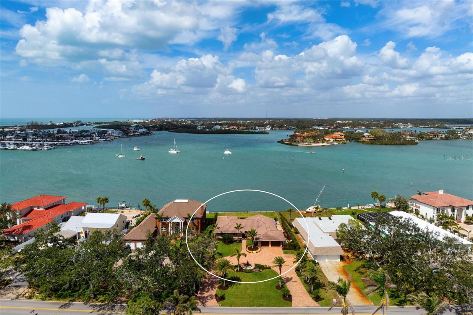 Breathtaking, expansive water views of Roberts Bay await you in this wonderful home in downtown Venice close to the beach and quaint shops. This home has been completely remodeled and professionally decorated by Clive Daniels and sold turnkey.  There are too many features to list individually.  To mention a few:  hurricane impact sliding glass doors and windows, new AC 2024, beautiful travertine tile that runs throughout, tile roof 2011, new whole house generator with separate automatic transfer during power outage plus a new seawall. As you drive up the circular driveway you see the lush landscaping that is fed by a 330 ft private well. Enter your home and to the right is the main living space which includes the living room, dining room, dinette area and kitchen all with stunning Bay views. Let’s highlight the kitchen with its Marine grade NEFF cabinets with stamped stainless and glass drawers.  There is a quartz countertop with a waterfall drop on the island and a breakfast bar.  Enjoy preparing meals on the gas stove with a stainless-steel hood. Need to escape the main living area? Relax in the separate family room with built-in shelving as well as another view of the water.  Retire to the primary bedroom and relax in the sitting area with a wall of impact glass windows and watch the boats go by or the sun setting. Plus 2 walk in closets.  The primary bath is stunning and en-suite.  Now let’s move outside! The serene water views are in every direction. Float in your infinity pool, relax in the hot tub or entertain on the expansive paver deck, whether in the covered or uncovered areas. There is even a fenced green space for your fury friends to play! No hurricane damage to this home. From this amazing waterfront home, you can easily access all the restaurants, quaint shops, the art center, the beach and all the Island has to offer.