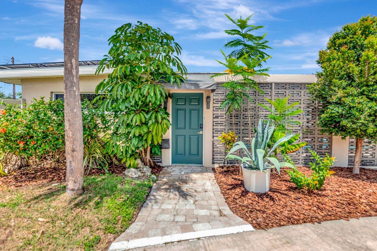 Built custom in 1957 by famed mid-century builder Mercer Harshaw, this beautiful residence captures the essence of St. Petersburg’s post-war architectural boom. Set behind a private U-shaped courtyard framed with classic breeze-block detailing, the home blends iconic mid-century design with flexible modern living.
Offering 4 bedrooms and 2 baths, the layout is exceptionally versatile. A thoughtfully designed wing features two bedrooms and a full bath with two separate entrances, allowing it to function seamlessly as an in-law suite, guest quarters, private office wing, or income-producing space. This rare configuration adds tremendous value and livability.
Inside, the home reflects the hallmarks of Harshaw’s craftsmanship: solid block construction, clean lines, abundant natural light, and an indoor-outdoor flow centered around the sun-filled courtyard. Large picture windows brighten the main living areas, while the kitchen and dining spaces maintain the home’s original charm with room for modern updates. Rest easy as this home has a newer roof and SolarEdge solar panels with a total output of 11.52 kW.
The courtyard serves as a true outdoor room-perfect for morning coffee, entertaining, or quiet evenings surrounded by patterned shadows and coastal breezes. The backyard offers additional space for gardening, pets, or future enhancements. The large side yard can easily satisfy an RV and or boat, making this the perfect primary residence or second home.
Located minutes from downtown St. Pete, Gulf beaches, and the vibrant shops and restaurants along Central Avenue, this home offers the perfect blend of architectural history, privacy, and convenience. A rare opportunity to own an authentic piece of St. Petersburg’s mid-century heritage, crafted by one of the City’s most respected builders. **Flood Zone X and zoned for building an ADU**