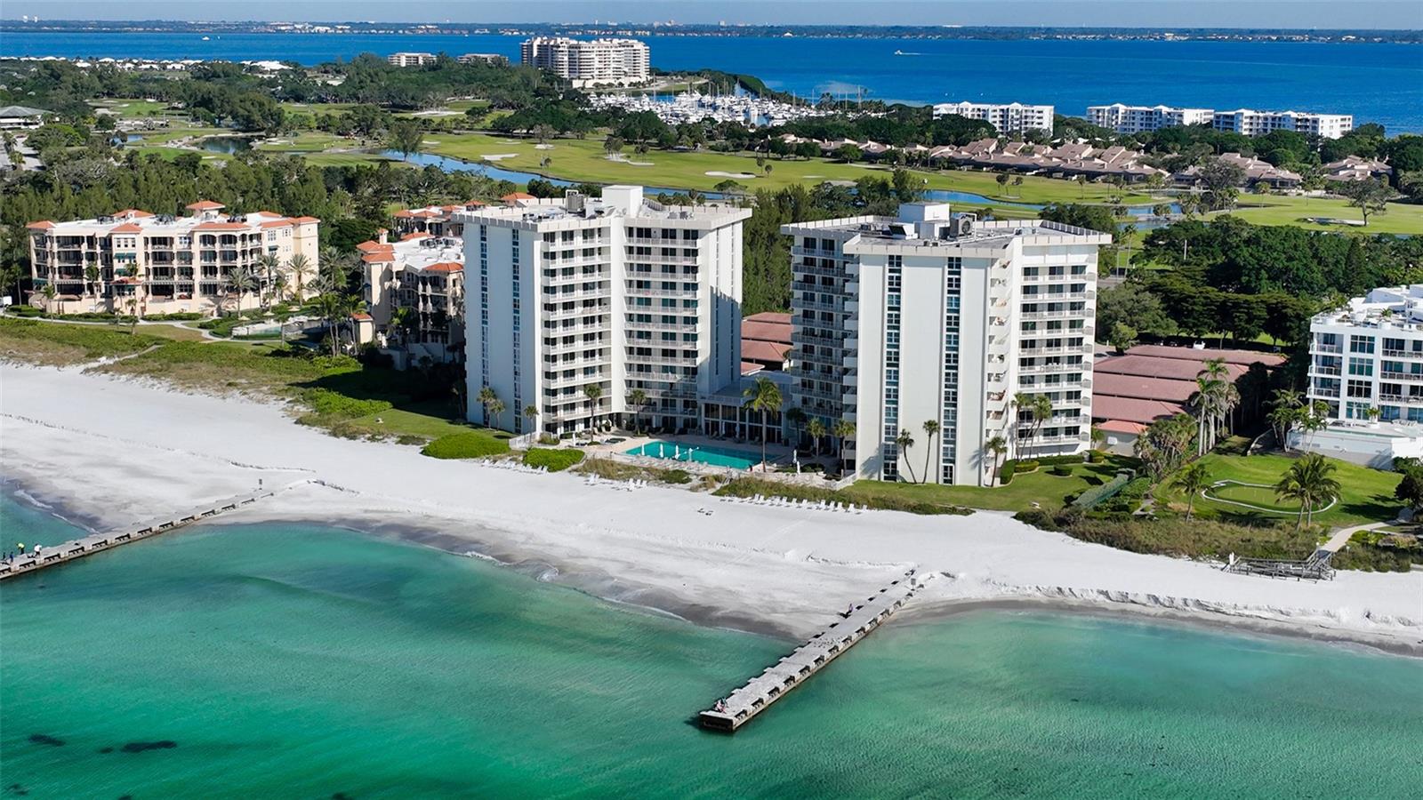 One or more photo(s) has been virtually staged. Perfectly positioned in the sought-after Islander Club Condominium, this 2-bedroom, 2-bath residence offers commanding Gulf and beach views from the living room, dining room, and both bedrooms. Expansive windows frame the sparkling waters of the Gulf of Mexico, creating a breathtaking backdrop for everyday living while showcasing spectacular sunset skies each evening. Situated front and center on the 4th floor, the residence enjoys one of the most desirable vantage points in the building, elevated enough for panoramic shoreline views yet close enough to feel immersed in the beauty and rhythm of the beach below. Competitively priced, the condominium presents a rare opportunity for the next owner to create their own vision of coastal living. Whether designing a sophisticated modern retreat or a relaxed island escape, the residence offers a blank canvas ready to be transformed to your personal taste and style—truly a chance to make it your own.
Residents of the Islander Club enjoy a collection of resort-style amenities including direct access to the pristine Gulf Beach, a beachfront Olympic size swimming pool, tennis courts, fitness center, clubhouse, library, and beautifully landscaped tropical grounds. Located on the coveted south end of Longboat Key, the community offers convenient access to Publix, the world-class shopping and dining of St. Armands Circle as well as the vibrant arts, cultural venues, and waterfront restaurants of downtown Sarasota. Go ahead – Make it your own and have it your way!