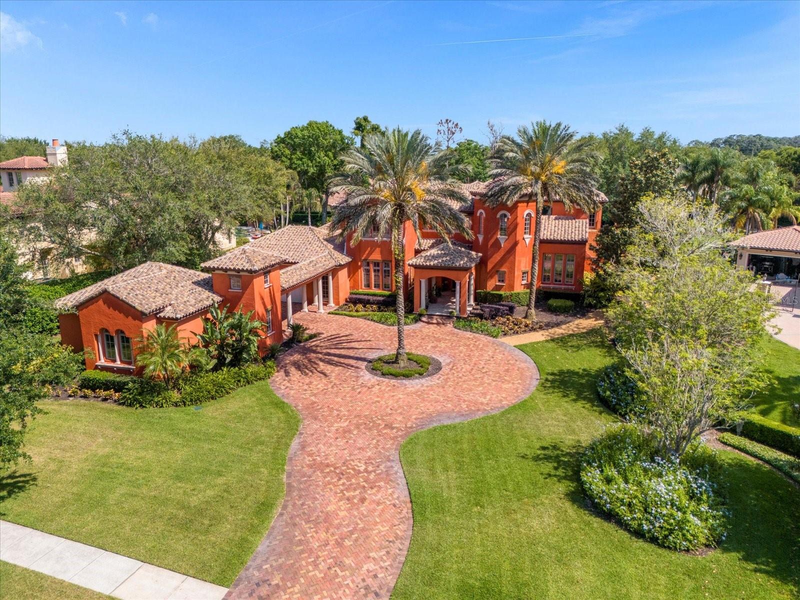 Welcome to Lake Butler Sound. This Tuscan-
inspired estate boasts architectural details and exquisite finishes throughout,
exuding refined elegance.

Step into an opulent masterpiece nestled within a luxurious 24-hour manned, gated
community, where garden parks and a waterscape entry greet you. 

With a total of 6 bedrooms, including a detached guest suite and a library/bedroom, this
estate offers unparalleled comfort and versatility. Upon entry, you’re welcomed by an
intimate formal parlor and a magnificent circular stairway, setting the stage for the
grandeur within.
The heart of the home lies in its gourmet kitchen, featuring a center island, walk-in
pantry, and a buffet serving bar, seamlessly connected to a breakfast dining bay
enveloped by a bay of windows and a wrap-around colonnade porch. Adjacent is a
butler’s serving pantry and an impressive dining salon with a gated wine cellar, perfect
for entertaining guests in style.
The expansive family room opens to a serene courtyard through French doors, while
the incomparable primary suite indulges you in luxury and privacy. A 2-way fireplace
separates the sleeping quarters from the primary bedroom spa, featuring a dual-head shower,
wardrobe room, and a sauna accessed from the meditation garden. The primary bathroom also includes a lounge with a morning bar which leads to a private lanai overlooking the garden and resort style pool. A separate spa, complete with waterfall features, is situated in the private courtyard. 

Upstairs, three additional bedroom suites, each with private baths and walk-in closets await.
Your spacious game/media room and a playroom are also located on the second floor. There is a total of 4 garage bays that are accessible by the brick paver motor court with a circular drive. The lavish landscaping around the entire home complete this exceptional
estate.

This residence seamlessly blends elegance and comfort, offering a lifestyle of
unparalleled luxury. With meticulous attention to detail and a serene outdoor oasis, this
estate invites you to immerse yourself in its grandeur and sophistication. This estate is available immediately.