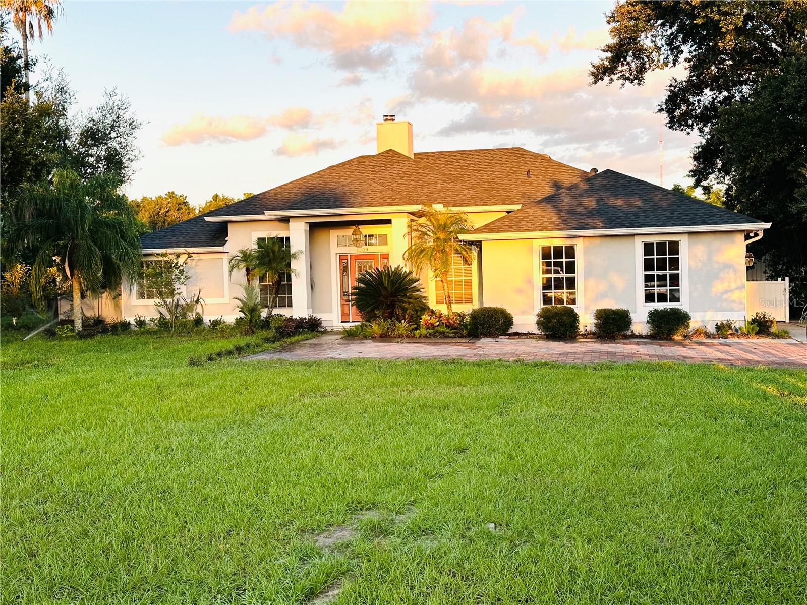 Welcome to this beautifully renovated 4-bedroom, 3-bathroom pool home, perfectly situated on 2 acres of agricultural land in Longwood with Lake Mary city limits. Originally designed as an equestrian estate, this unique property offers the perfect blend of modern living and rural charm.
The home was completely updated in 2022 and features a stylish kitchen with newer cabinetry, granite countertops, and ample space for entertaining. All bathrooms have been thoughtfully renovated with elegant ceramic tile, glass-enclosed showers, and LED mirrors, creating a sleek, contemporary feel. 
The spacious primary suite offers a comfortable retreat with a large walk-in closet, while the additional three bedrooms are generously sized and include built-in closets.
Step outside to enjoy your private oasis—featuring a fully resurfaced pool and freshly painted pool deck, ideal for relaxing or hosting gatherings. The expansive property also includes approximately 8,000 square feet of installed pavers throughout the driveway and surrounding areas, adding both functionality and curb appeal.
Equestrian enthusiasts will appreciate the well-equipped barn with 4 stalls, a feed room, and 4 shower poles—ready for your horses or farm animals. 
Additional upgrades include a new roof (2022), new well system and pump, tankless water heater, and an electric gated entrance for added privacy and security.
This one-of-a-kind property offers space, upgrades, and versatility—don’t miss your opportunity to own a truly special estate. Schedule your private showing today!