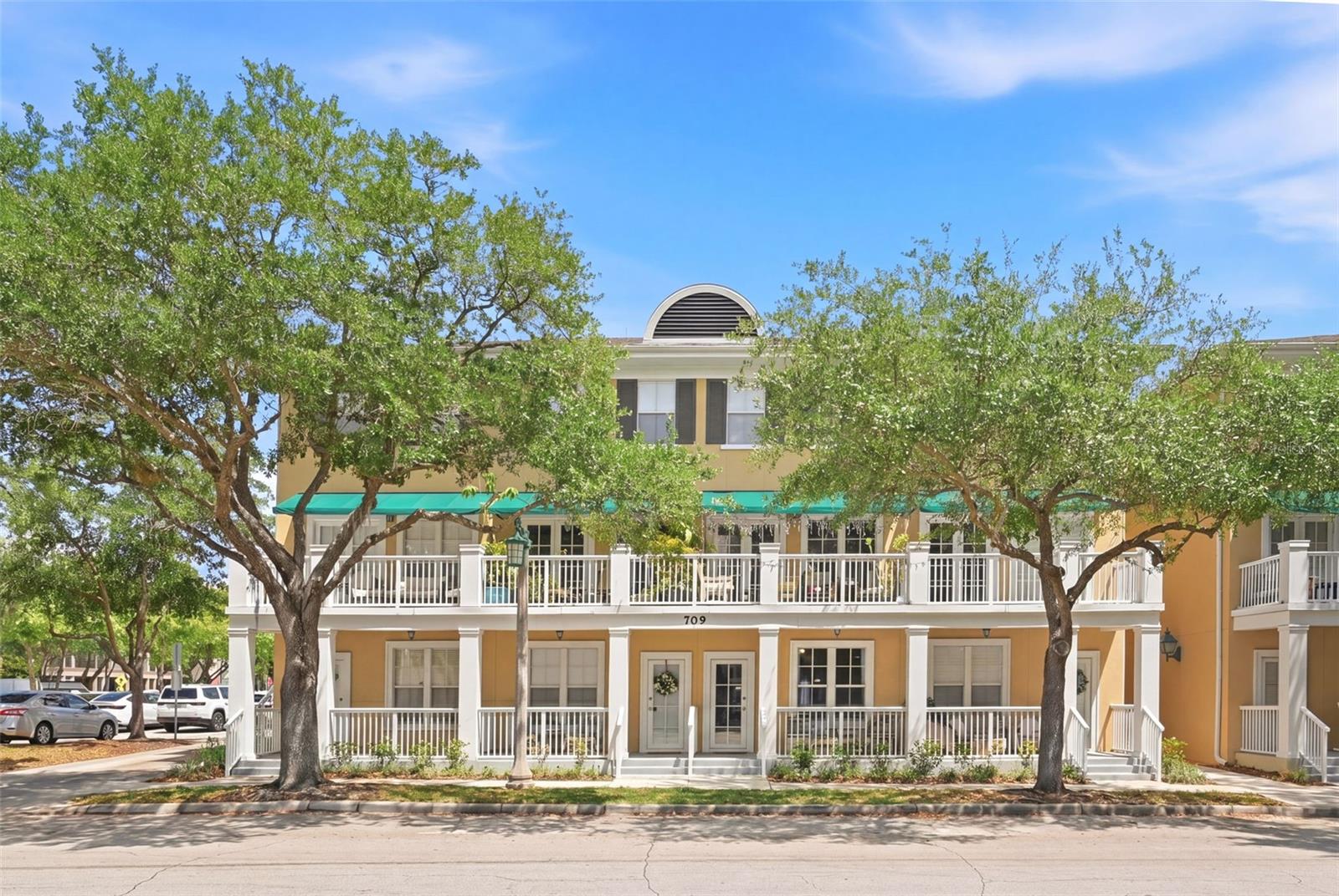 One or more photo(s) has been virtually staged. If you’ve been waiting for the perfect place to call home… this is it!

This absolute stunner sits on the ground floor right in the heart of downtown Celebration, meaning all of the town’s charm, events, shops, and dining are literally just steps from your front door. You are across the street from the Inn at Celebration (as well as Lake Rianhard) and right in the middle of all the magic in thie town built by Disney.

From the moment you walk in, this home has that wow factor. It’s truly turn-key with updates throughout and a layout that just feels right. This unit features BOTH a front porch and a private fenced-in back patio. These do not come up often, and it’s the kind of indoor-outdoor living that makes Celebration so special.

The front porch is truly one of the standout features of this home as it's the perfect place to sit back, relax, and take in all that Celebration has to offer. Whether you’re enjoying your morning coffee or winding down in the evening, you’ll have picturesque views of Lake Rianhard paired with a front-row seat to the charm of downtown. From peaceful lake views to a little fun “tourist watching,” it’s the best of Florida living all in one spot- laid-back, scenic, and full of life.

Inside, you’ll find a beautifully updated kitchen with stainless steel appliances, a custom externally vented hood, and an eat-in space that flows perfectly into the living area. The custom-built fireplace and TV wall create a stunning focal point, while built-in bookshelves add both charm and function.

The home also features an updated bathroom, reverse osmosis water filtration system, newer plumbing and electrical, newer AC with a NEST thermostat, ceiling fans, LED lighting, and tile flooring throughout. No carpet anywhere!

The back porch is just as inviting and incredibly practical. It’s the perfect space if you have pets, giving them a secure, fenced-in area to enjoy, or a quiet spot for you to sip lemonade in the afternoon or unwind with a glass of wine in the evening. Plus, with the fence backing up to the parking lot, you get easy, convenient access. Bringing in groceries or everyday essentials is an absolute breeze.

Washer and dryer are included so all you need to do is pack your things, bring your personal touches, and start enjoying your new space from day one.

This unit feels elevated and just a little bit magical. Celebration itself is truly one of a kind, with a lifestyle centered around community, connection, and that unmistakable Disney charm. With Disney World so close you will feel like you are living at the parks!

Opportunities like this, especially in this location with these features, are rare. You do not want to miss this one!