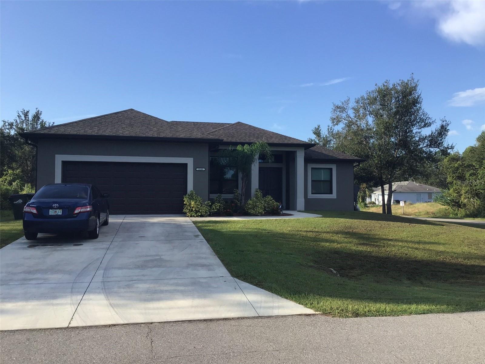 WHY BUILD? 
This  2019 Custom Built home is ready for you!  This beautiful home is situated on a corner lot.   Featuring a spacious open floor plan with 3 bedrooms 2 full baths, Family room, separate Dining, Sun room, inside Laundry, & 2 Car Garage.  This home includes many upgrades, including: hurricane impact windows & doors, water resistant laminate floors throughout, recessed interior and exterior lights, crown molding in the main living areas with soaring 12 ft ceilings,  10 ft ceilings throughout the remainder of the home, remote controlled fans in main living areas and a spacious back patio.  Kitchen upgrades include custom soft close cabinets/drawers, stainless steel appliances, upgraded granite counter tops with plenty of prep area and an eat-in island that comfortably fits 4. The kitchen has an under the sink RO system.  In addition to the ample cabinet space, off the kitchen there is a large pantry. In the owner's suite you'll find tray ceilings, custom built in closet organization, and a luxurious bathroom with separate his and her sinks, large garden tub, and tiled walk in shower.  Recently added features includes an enclosed sun room with low-E energy efficient windows, solar power for an extremely low energy bill, and two full house Tesla batteries to allow full house power back up in case of outages and protection from surges for around the clock power & a well water filter using hydrogen peroxide and carbon-based filtration.  1 year Home Warranty included PLUS seller offering 1 point with an acceptable offer by 11/20/23
To see this beautiful home call today for you very own private tour!