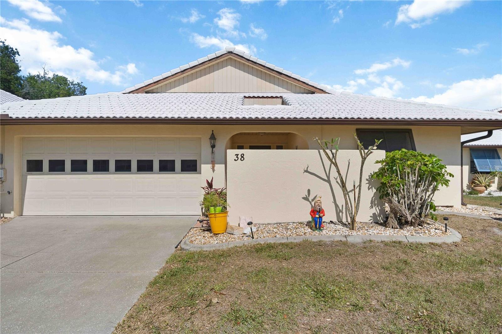 Discover Hourglass Lake Villas — an intimate community of just 80 villas, welcoming of all ages, and one of South Venice's most quietly coveted addresses. Just minutes from Venice Island, Manasota Key, Gulf beaches, dining, and shopping, the location is as effortless as the lifestyle. Tucked in near the front of the neighborhood, this waterfront two-bedroom, two-bath villa offers a thoughtful split-bedroom layout with a hidden pocket door that creates a fully private guest suite with its own bath. A bright lanai with sliding glass doors connects the living area and primary suite, while a private courtyard off the kitchen and primary bathroom invites you to start mornings at your own pace or enjoy a beautiful cross breeze through the home. Thoughtful details throughout — adjustable exterior Bahama shutters for filtered light and privacy, generous storage including a walk-in primary closet and attic access, and a well-appointed eat-in kitchen with a newer stainless steel refrigerator and dishwasher, recessed lighting, and abundant cabinetry. The laundry room includes a utility sink and additional storage space, which leads out to the oversized two-car garage. The low HOA includes a heated and cooled pool, spa, private clubhouse, professional landscaping, and an active social calendar — a true lock-and-leave lifestyle with the warmth of a close-knit community. Schedule your private showing and experience this Venice retreat for yourself.
