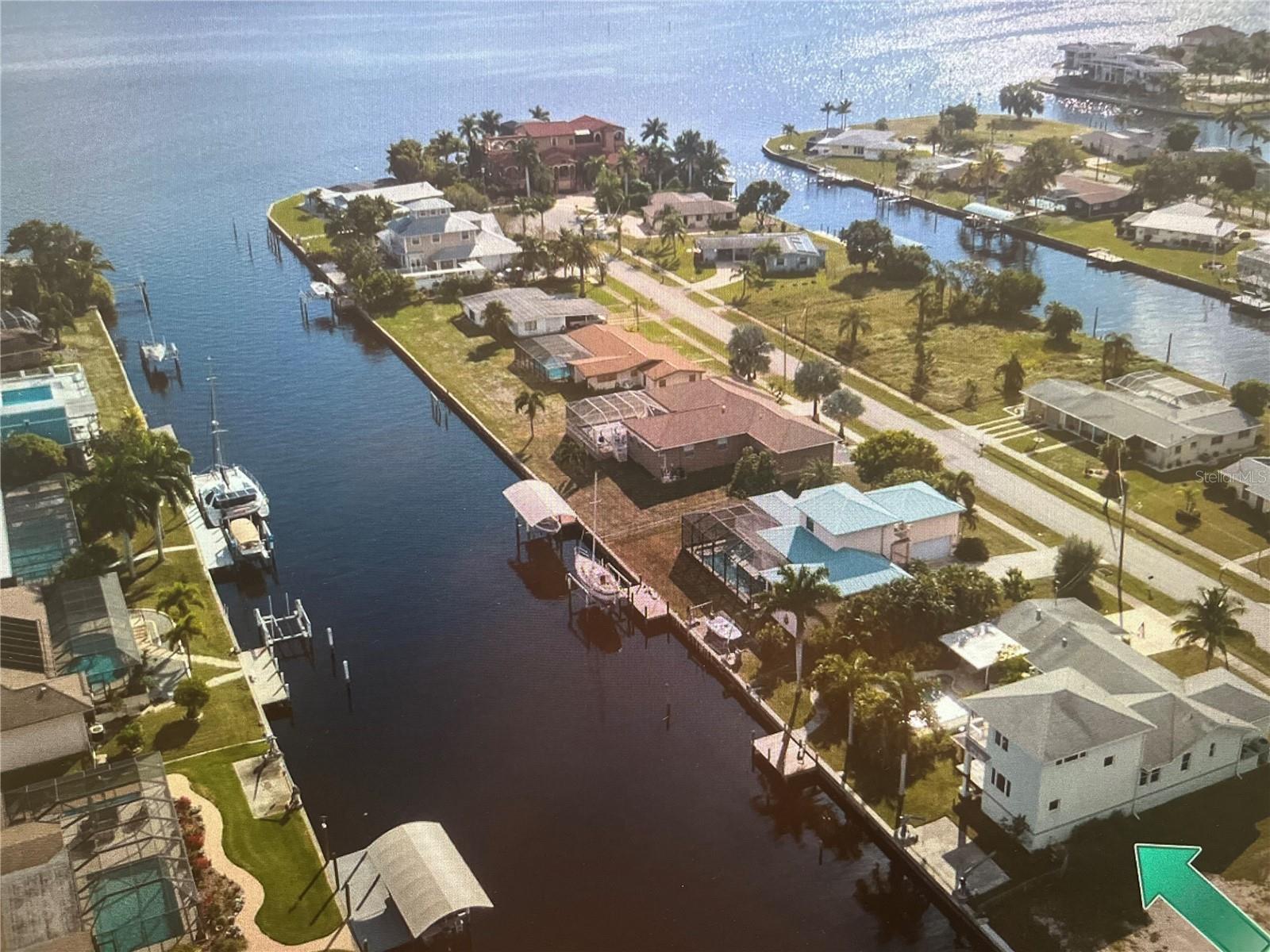 Looking for your private oasis? Look no further!PRIVATE POOL HOME!TURNKEY!GREAT ELEVATION (see seller disclosure).

Exceptional attention to detail is found throughout this rare, one-of-a-kind custom sailboat waterfront home, where casual elegance welcomes you from the moment you enter. Boasting 100 feet of waterfront with direct access to Charlotte Harbor and the Gulf of Mexico, this property is a true paradise for boating and fishing enthusiasts.

Surrounded by lush tropical landscaping, enjoy your private open-air pool and deck, offering the ultimate Florida waterfront lifestyle.

This custom two-story home features water views from nearly every room and includes 3 bedrooms, 2 full baths, and 1 half bath. The spacious great room flows into a well-appointed kitchen with abundant cabinetry, coffered ceiling, and top-of-the-line stainless steel appliances, including a gas range. Additional features include a study/den and a dedicated laundry room.

The private owner’s suite offers a balcony overlooking the water and pool, perfect for enjoying sunrise views. The en-suite bath includes a soaking tub with tranquil waterfront views.

Designed for indoor-outdoor living, the covered patio off the great room leads to a 17.5 x 32 heated pool with a depth of nearly 9 feet and a shallow bench area for relaxation. There is also an additional covered patio space adjacent to the pool and a detached 1+ car garage with a half bath.

Boating features include a concrete seawall, boat pad, and 5,000 lb davits.

Built in 2006 with solid masonry construction, this home includes filled block construction, PGT hurricane impact windows, extra interior wall insulation, zoned A/C systems, and ample storage throughout.

Conveniently located near the Port Charlotte Beach Complex, public boat ramp, tennis, golf, pickleball, shopping, dining, and downtown Punta Gorda, as well as North Port and the Punta Gorda Airport.

Public water and public sewer.

Schedule your private showing today and experience the best of Southwest Florida waterfront living.
