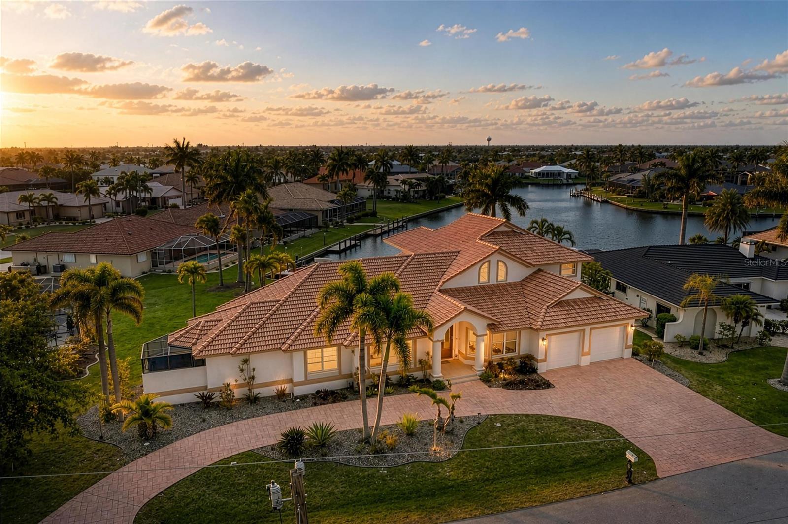Tucked away on a quiet cul-de-sac, this exceptional custom-built waterfront residence includes a boat with private dock and 10,000 boat lift! This home blends timeless design with modern upgrades and an ideal layout for both everyday living and entertaining. From the moment you enter, soaring volume ceilings and a formal living room better used as a game room with dining spaces nearby set the tone for the home’s spacious and refined feel.

At the heart of the home, an expansive family room showcases stunning floor-to-ceiling windows that frame wide basin waterfront views, filling the space with natural light. A dry bar enhances the entertaining experience complete with upper glass storage cabinets, a beverage wine fridge, while the open, chef-inspired kitchen features a large quartzite island with complementary marble countertops, stainless steel built in double ovens, and an extraordinary amount of custom cabinetry—truly a standout feature rarely seen.

The private first-floor primary suite is a true retreat, offering direct access to the lanai, a huge custom walk-in closet, and a beautifully remodeled spa-like bath with soaking tub and dual vanities. Also on the main level, you’ll find a dedicated executive office, an additional guest bedroom or bonus room (could be a second office), a full bath with lanai/pool access, a convenient half bath, and a spacious laundry room with utility sink and extra storage.

Upstairs, guests are welcomed with two generously sized bedrooms, a full bath, a loft area, and their own private balcony overlooking the water—perfect for enjoying serene Florida sunsets.

Outdoor living is just as impressive, with an oversized lanai and summer kitchen creating a seamless extension of the home. The recently added pool and spa (2020) with paver patio provide the ultimate space to relax and entertain while taking in the tranquil waterfront setting.

Additional highlights include an oversized 2-car garage with extra storage and potential for tandem parking, circular driveway, fenced backyard, full hurricane protection with impact glass at the front and shutters elsewhere, a new 4-ton A/C (2026), and beautifully updated kitchen and primary bath with today’s most desirable finishes.

Located just minutes from dining, shopping, parks, bike and walking paths, and the charm of downtown Punta Gorda, this home offers the very best of the Florida waterfront lifestyle. - BOAT INCLUDED (WILL PROVIDE SEPARATE BILL OF SALE).