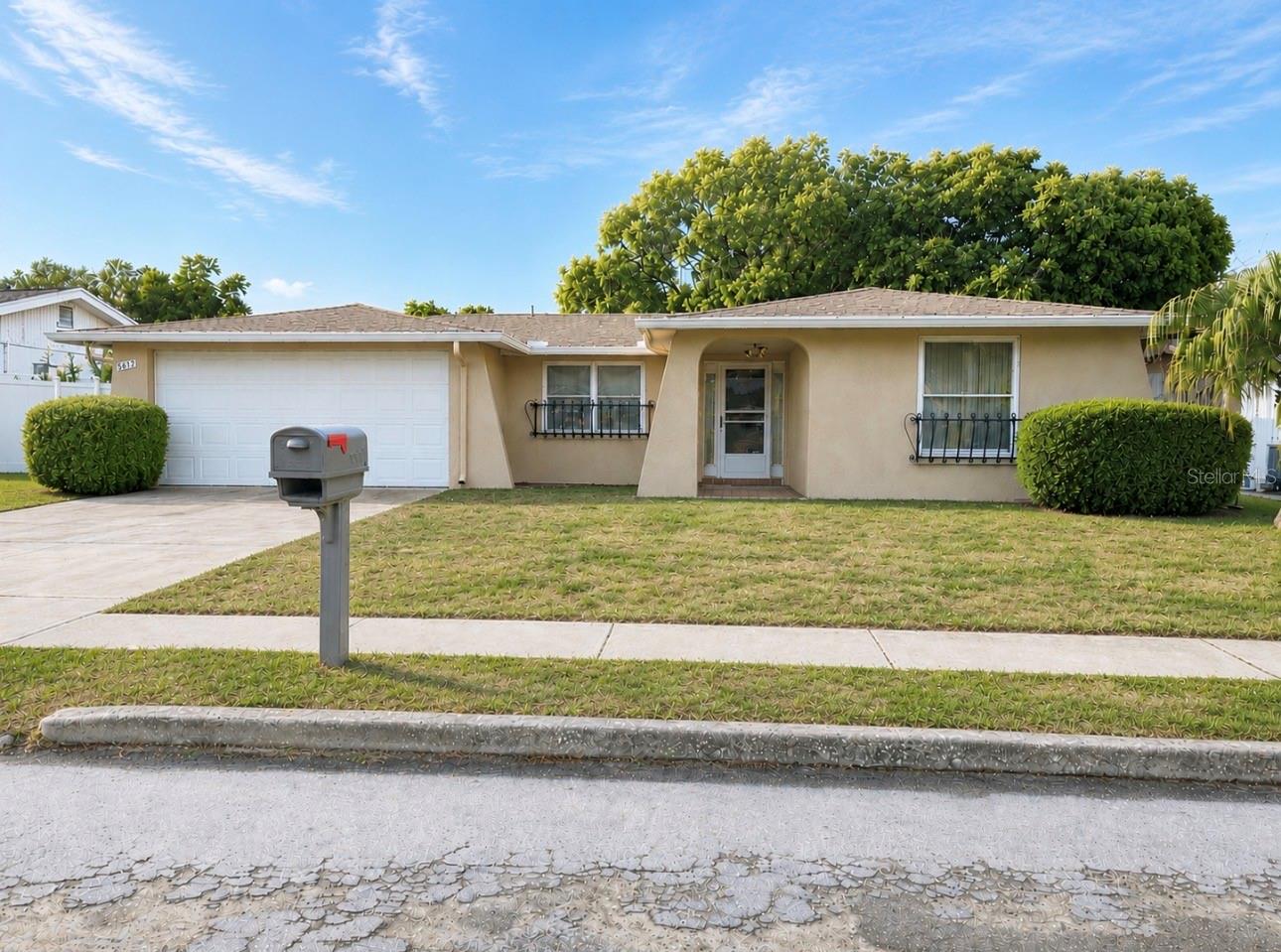 Welcome home to this IMMACULATELY MAINTAINED gem in the heart of Holiday! This move-in ready home offers 2 HUGE bedrooms, 2 full bathrooms, and a 2-car garage. Inside, you'll find both a comfortable living room AND a versatile family room/flex space that can easily be converted into a third bedroom, home office, or playroom with the addition of two stylish sliding barn doors. The kitchen has an eat-in area and the home also offers a separate dining room too. A screened in back porch completes the home.

Major updates provide peace of mind, including a 2020 shingle roof, 2023 flat roof, 2016 HVAC system, and replacement windows throughout. Timeless 16" tile flooring flows through the main living areas and primary bedroom, while the guest bedroom features warm, comfortable carpeting. This exceptionally clean home is truly MOVE-IN READY and offers the flexibility today's buyers are looking for!

Whether you're a first-time homebuyer, downsizing, or looking for a seasonal Florida home, this property checks all the boxes with its flexible layout, excellent condition, and desirable location near shopping, restaurants, parks, medical facilities, beaches, and the Gulf of Mexico. Don't miss your opportunity to own this great Holiday home!