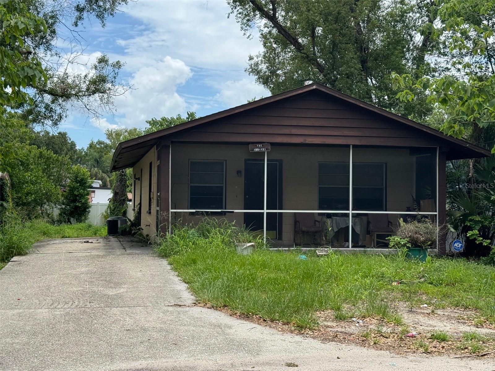 This property presents an excellent opportunity for investors or buyers seeking a renovation project. The home features 2 bedrooms and 1 bathroom, along with a welcoming enclosed front porch and two storage sheds for added convenience. The spacious backyard offers exceptional versatility and potential for outdoor living, gardening, storage, or future improvements. Located outside a flood zone, the property does not require flood insurance and has no HOA or CDD fees, helping to keep ownership costs low. Conveniently situated near major commuter routes, the home provides easy access to I-275 and is just minutes from Busch Gardens, shopping centers, restaurants, medical facilities, the University of South Florida, and downtown Tampa. A rare opportunity that combines space, flexibility, affordability, and long-term potential in a highly accessible Tampa location