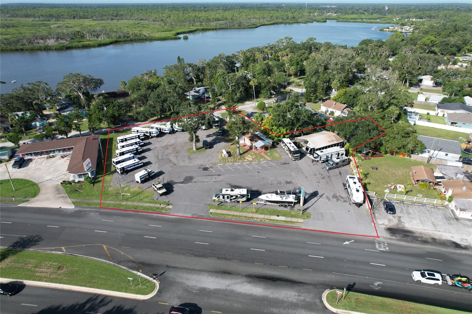 Great investment opportunity located just over the Rose Bay bridges and only moments to New Smyrna Beach.  With over 200' of frontage on US Highway 1 and additional frontage on W. Bayshore it is highly visible and very accessible.  There are 2 parcels and addresses included in this sale with them totaling .85 of an acre of land, 16,238sf of paved asphalt, and approximately 8,200sf of asphalt millings.  The main office building includes a showroom, storage room, 2 bathrooms, kitchen, 3 private offices, and a large open office space holding 2 additional work areas.  Also included is 20'x40' wood & metal building with 10'x20' porch space, 30'x40' open carport, 5 power meters, and six 50 amp power hookups and 4 water hookups.  Currently property is being used for RV dealership and service center.  Zoning is RD - Ridgewood development district, allowing for a huge variety of businesses. ;Water: City