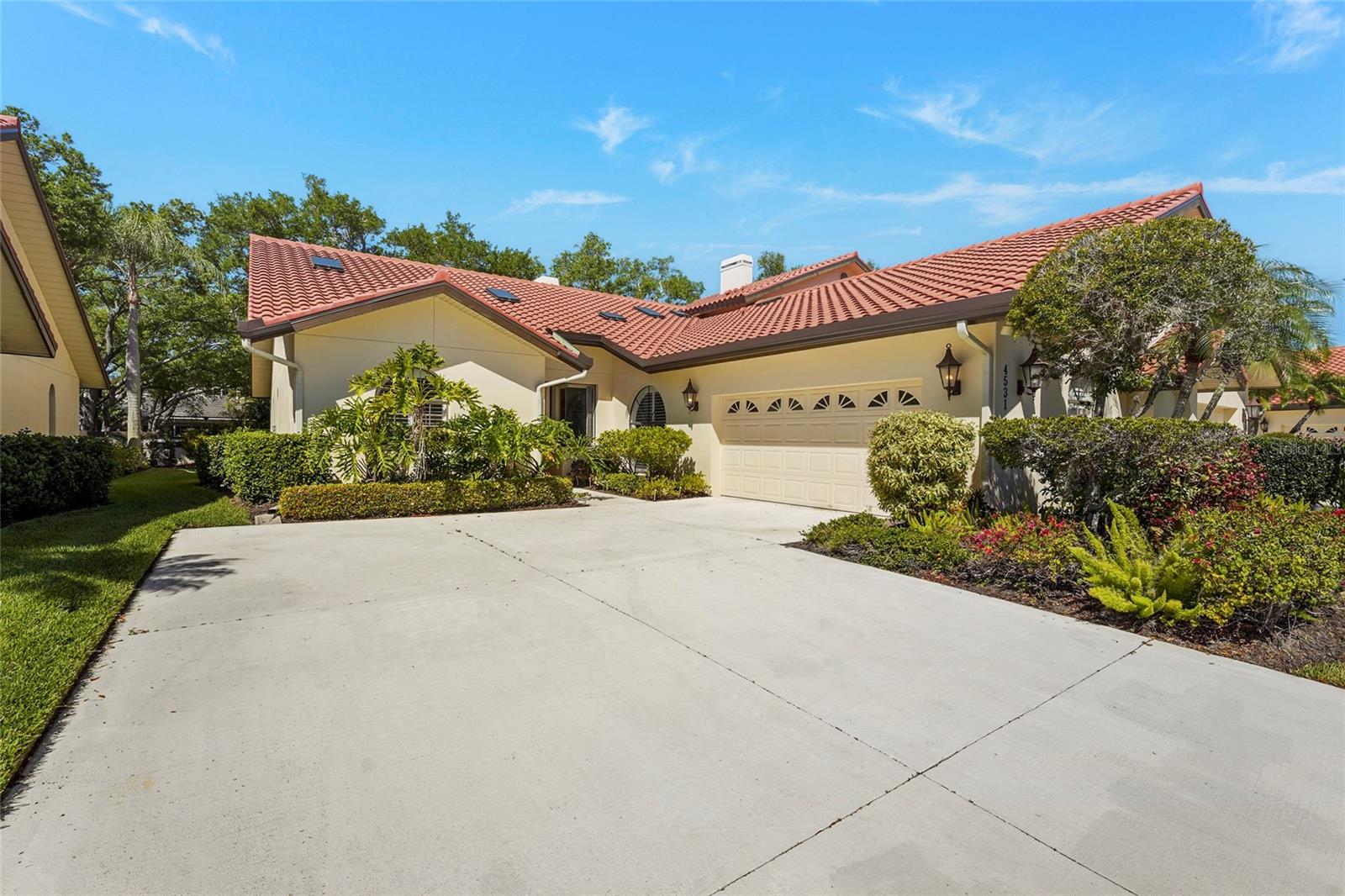 Virtually Staged. Enjoy maintenance-free living at its finest in this stunning 2-bedroom, 2-bath villa + den, located within the 24/7 guard-gated (with two entrances) Prestancia golf community, in the highly sought-after enclave of Villa D’Este. A picturesque drive along Prestancia Boulevard, lined with majestic oak trees forming a beautiful canopy, leads you into this serene neighborhood. Surrounded by two championship golf courses, wetlands, cypress heads, ponds, and lagoons teeming with wildlife, Prestancia is proudly recognized as a sanctuary by the Audubon Society.

This residence features soaring ceilings and multiple skylights throughout, creating a bright, open, and inviting Florida-style atmosphere. Plantation shutters adorn all exterior windows, adding both elegance and functionality. A brand-new concrete tile roof, along with new skylights, gutters, downspouts, and fascia, ensures peace of mind for years to come.

The spacious living room showcases a wood-burning fireplace and built-in wet bar, seamlessly connecting to the tiled lanai via pocket sliders. This villa offers a rare extended lanai—stretching nearly the full length of the rear of the home —a feature found in very few villas in the community. 

The adjacent dining room, complete with a built-in buffet, continues the home’s modern elegance. The large eat-in kitchen is light and bright, featuring newer cabinetry, granite countertops, stainless steel appliances, a breakfast nook, a separate desk area, soffit lighting that highlights the volume ceilings, and ample storage.

Recent upgrades include a home security system with an electronic lock, a new secure locking screen door at the lanai, privacy screens, and interior locking hurricane shutters.

The primary suite serves as a private retreat with direct lanai access and a spa-like bathroom featuring a Jacuzzi tub, walk-in shower, dual marble vanities, and a generous walk-in closet. The guest bathroom includes a soaking tub and a stylish glass vessel sink. A spacious den with a skylight and contemporary ceiling fan offers flexible space for a media room, office, or additional living area. The rear bedroom is equipped with a queen Murphy bed, built-in cabinetry, and a desk, making it ideal as either a guest room or home office.

Residents of Villa D’Este enjoy access to a beautifully maintained community pool and spa. Optional membership to TPC Prestancia Golf Club provides access to two 18-hole championship courses, along with dining and social activities. Conveniently located near shopping, dining, the Legacy Trail, and world-renowned Siesta Key Beach, this exceptional villa offers the perfect blend of elegance, modern upgrades, and the Sarasota lifestyle.