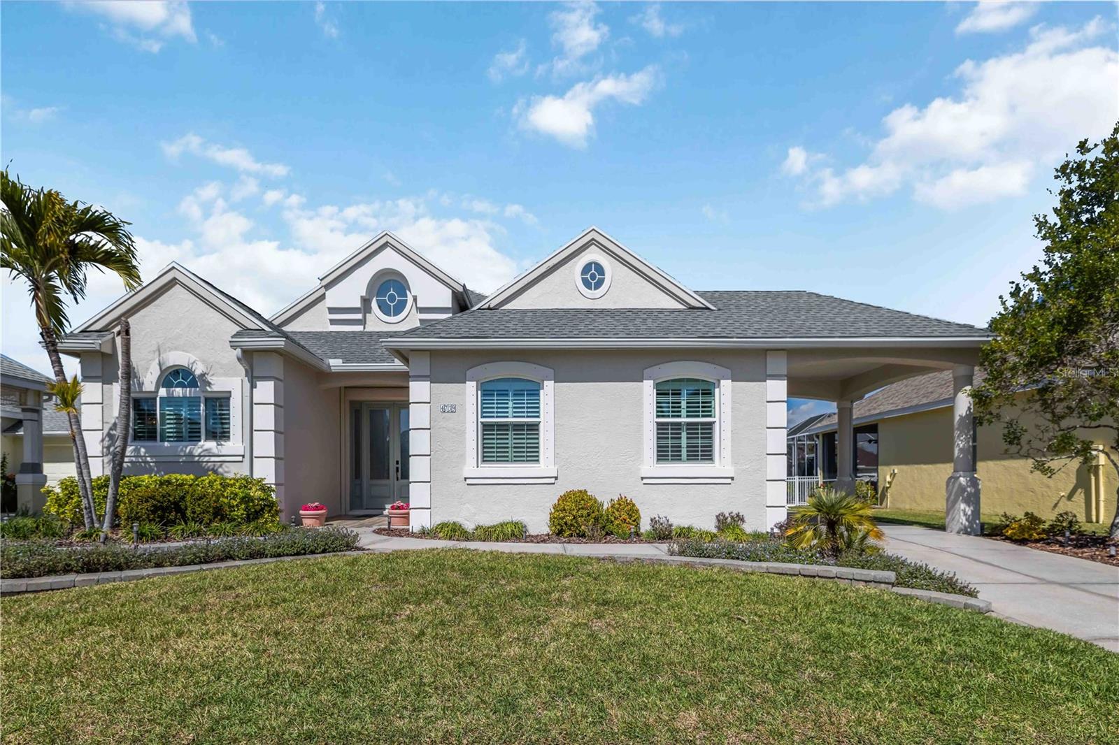 WELCOME TO THE FLORIDA LIFESTYLE YOU'VE BEEN WAITING FOR - AT A BRAND NEW PRICE - COMPLETE WITH YOUR OWN PRIVATE INGROUND SPA FOR THOSE PERFECT FLORIDA EVENINGS! This property qualifies for a 1% lender credit when using preferred lender. Inquire for details. Some homes check boxes. This one changes your life. Nestled in The Inlets — one of Bradenton's most coveted waterfront boating communities — this impeccably renovated 3-bedroom + den, 2.5-bath coastal retreat delivers the perfect blend of refined elegance, modern performance, and effortless Florida living.
Professionally transformed in 2021 with no detail overlooked, every inch of this home reflects exceptional craftsmanship and intentional design. Step through the striking hurricane-rated front door into a bright, open floor plan where 10-foot ceilings, coffered details, custom millwork, crown molding, shiplap accents, board-and-batten finishes, and premium engineered flooring create an atmosphere that is both stunning and welcoming. Expansive sliding glass doors dissolve the line between indoors and out, flooding the space with natural light and framing your private outdoor oasis.
The chef-inspired kitchen is as functional as it is beautiful — featuring level granite countertops, 42" custom white maple cabinetry with pull-outs, stainless steel appliances including a Bosch dishwasher and double oven range, a beverage cooler, and generous pantry storage. Whether you're hosting after a day on the water or enjoying a quiet evening in, this kitchen delivers.
Retreat to the private owner's suite, a true sanctuary featuring dual custom closets and a spa-inspired bath finished with premium tile and designer touches. Two guest bedrooms are thoughtfully positioned at the front of the home for maximum privacy, and every bathroom has been tastefully renovated to match the home's elevated standard.
Outside, the Florida dream comes alive. Unwind in your heated inground spa — complete with new heater, pump, and filter (2022) — surrounded by lush tropical landscaping designed for privacy and beauty. Then head down to your deep-water private dock with water and electric, where the Manatee River, Tampa Bay, and the Gulf of Mexico are quite literally at your fingertips. This is not just a home — it's a lifestyle with a direct line to the water.
The rare 3-car garage space with finished flooring offers exceptional storage for water toys, equipment, vehicles, or whatever your Florida lifestyle demands.
Major updates for total peace of mind:
New Roof (2019)
HVAC Replacement (2021)
Hot Water Heater (2022)
ENERGY STAR Low-E Windows (2022)
Hurricane Roll-Down Shutters (2021)
Automatic Kevlar Storm Shades (2021)
Hurricane-Rated Front Door System (2021)
Interior & Exterior Paint (2022)
New Gutters (2023)
Beyond your doorstep, The Inlets community offers a waterfront park, tennis courts, canoe and kayak launch, playground, and nature trails — all wrapped in an active, welcoming social atmosphere with low HOA fees and NO CDD fees.
Perfectly positioned near downtown Bradenton, Sarasota, world-class Gulf beaches, premier dining, shopping, and I-75, this move-in ready gem puts everything within easy reach.
Boating. Beauty. Peace of mind. Welcome home.
