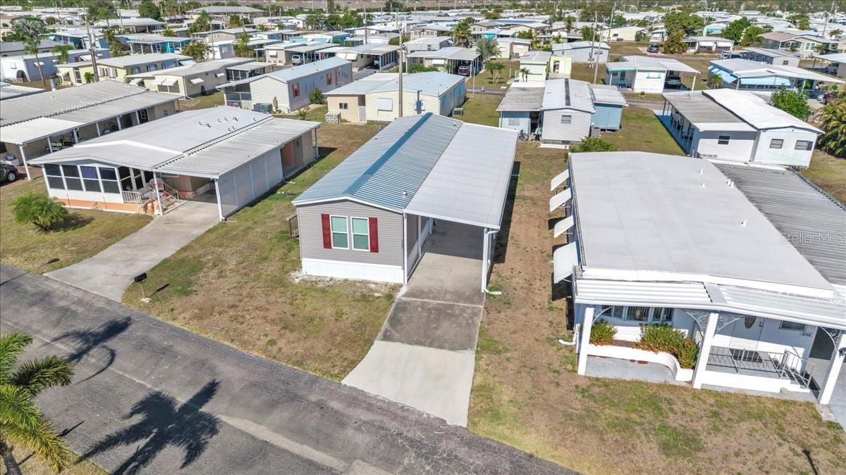 Seller to pay first 6 months of Lot Rent. Welcome to the 55 & over Tamiami Village in North Fort Myers! From the moment you step inside, you’ll love this brand-new 2024 single-wide, 2-bedroom, 2-bath home with a covered carport. Thoughtfully designed with a bright, open-concept layout, the kitchen flows seamlessly into the living and dining areas, creating a spacious feel rarely found in a single-wide modular home. The kitchen is the heart of the home, featuring a large center island with bar seating—ideal for casual dining and entertaining—along with modern pendant lighting and a sleek stainless-steel sink and faucet. Crisp cabinetry with upper crown molding, stylish countertops, and stainless-steel appliances, including a European-style range hood, offer both functionality and contemporary appeal. Open sightlines keep you connected to the living and dining spaces, while durable luxury vinyl flooring throughout provides a cohesive look and easy maintenance. The primary suite includes a private en-suite bath with a dual-sink vanity, a walk-in tiled shower with a rainfall showerhead, and a walk-in closet. The guest bedroom offers a spacious built-in closet and convenient access to a full bathroom. A full-size washer and dryer are conveniently located in the hallway, completing this well-appointed home. Additional highlights include transferable warranties, featuring a 10-year structural warranty and 7-year systems and appliance warranties for added peace of mind. Exterior construction features include a durable 29-gauge Power Ribbed metal roof with a Cool Chemistry coil coated finish, fully vented vinyl soffits beneath 8-inch overhangs for improved airflow, and vinyl Thermopane windows with Low-E glass to enhance energy efficiency and comfort year-round.  This Home is conveniently located within a short walking distance of the pool and Clubhouse. Tamiami Village Offers an Abundance of Amenities, Including 3 Swimming Pools, a Spa, Shuffleboard Courts, Horseshoes, Billiards, Two Clubhouses, a Fitness Center, Library, and a Variety of Social Activities. Join this Vibrant and Active Community Today!
**PLEASE ENJOY THE 3D INTERACTIVE VIRTUAL TOUR ASSOCIATED WITH THIS LISTING**
