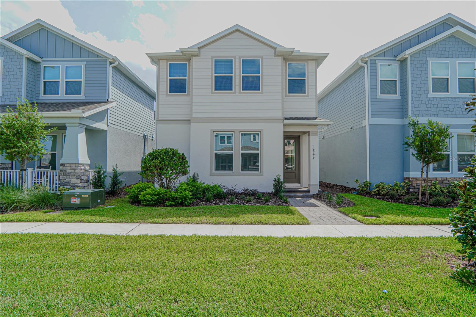 Discover elegance, comfort, and versatility in this stunning home located in the highly sought-after Harvest at Ovation community in Winter Garden. Ideally situated at 16277 Honey Harvest St, this beautiful residence offers sophisticated design, spacious living areas, and an unbeatable Central Florida location close to everything you need.

From the moment you arrive, you are welcomed by a charming front porch surrounded by landscaped gardens, creating a warm and inviting first impression. Inside, the grand foyer opens to a bright open-concept floor plan with soaring ceilings and abundant natural light, perfect for modern living and entertaining.

On the main floor, you’ll find a private guest suite with a spacious full bathroom, offering comfort and privacy for family or visitors. The impressive living room features high ceilings and flows seamlessly into the designer kitchen, complete with quartz countertops, custom cabinetry, stainless steel appliances, and a large center island ideal for gatherings and everyday living.

Upstairs, the luxurious primary suite serves as a private retreat, featuring a spa-inspired bathroom and an oversized walk-in closet. Additional bedrooms, a full bathroom, and a conveniently located laundry room complete the second floor.

One of the home’s most unique features is the spacious bonus suite located above the garage, offering a private entrance and full bathroom. This versatile space is perfect for a guest suite, home office, media room, gym, or even a potential rental opportunity.

Enjoy Florida living year-round on the covered lanai with direct access to the attached two-car garage.

Residents of Harvest at Ovation enjoy resort-style HOA amenities, including a community pool, clubhouse, fitness center, playgrounds, walking trails, dog park, and beautifully maintained green spaces. The HOA also provides common area maintenance and access to all community recreational facilities.

Perfectly located just minutes from Disney attractions, Horizon West, Hamlin Town Center, top-rated schools, shopping, dining, major highways, and entertainment, this home offers the ideal combination of luxury, convenience, and lifestyle.

Don’t miss this incredible opportunity to own a beautiful home in one of Central Florida’s most desirable communities!