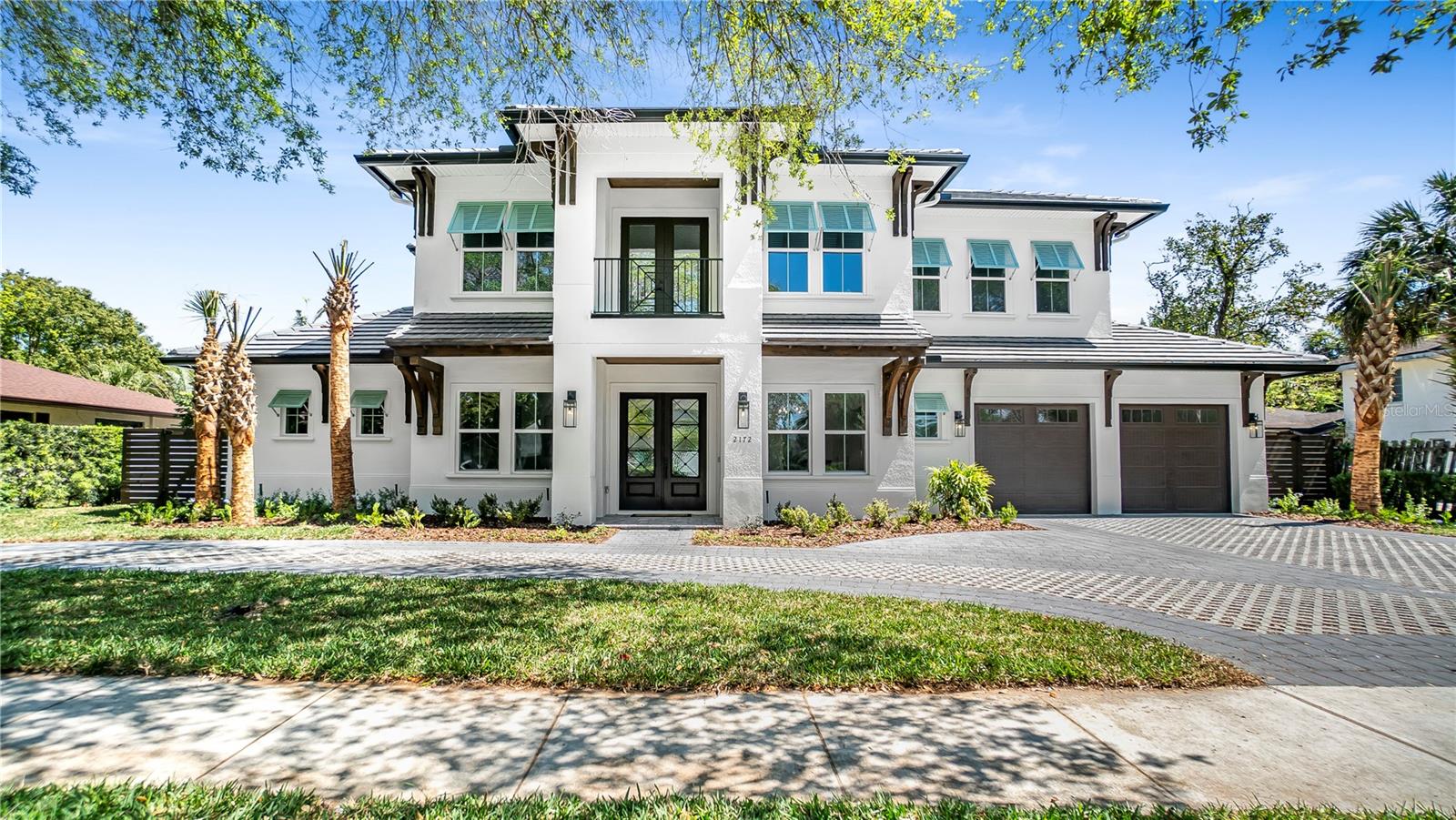 Elegance, comfort, and a welcoming environment blend cohesively at this chic British West Indies inspired new construction home positioned in one the most highly desirable places to live in the City of Winter Park. This magnificent five-bedroom, four-bath pool/spa home embraces high-end finishes and true quality craftsmanship that can be noted throughout. First glance upon arriving to the booming two-story home is the mature landscaping design that has a tropical feel. The floor plan is filled with hand-selected, engineered-hardwood flooring, natural light, and elegant fixtures filling the open-concept entertaining spaces creating an elevated living experience. Your inner home chef will delight in taking advantage of the oversized kitchen designed with exquisite cabinetry, oversized grand island, gas cook-top and opulence of high-end appliances. Dine in the formal dining that features a frameless glass walk-in wine closet with dry bar and wine chiller for the best selections of wines for entertaining. After a long day head over to the first-floor huge primary suite and primary bathroom for tranquility and relaxation that represents opulence and elegance. Additionally, the luxurious primary closet was designed to give gratification and enjoyment on a daily basis. This breathtaking custom-built home offers 10 ft high ceilings on the first and second floors and a guest suite on the first floor for privacy for all. The second floor offers three-bedrooms and two baths with one being an En-suite. The second floor Playroom/Entertaiment room sits perfectly between the second-floor bedrooms. To add, fourteen high-end audio speakers fill the home, pre-wired for security cameras and pre-wired Ev charging located in the massive two-car garage. The paradisaic setting is filled with functional and intricate landscaping that compliments the natural surroundings, including the huge functional open or closed screened Lanai with views of the nice sized heated salt/water pool and huge spa that can entertain plenty of a guest. To add, the summer kitchen is well equipped with a gas grille and chiller for beverages and prep space. This marvelous home additionally includes a private flex room/office and a large U-shaped driveway that offers high-end pavers for easy entering and exiting the property.  Winter Park Racquet Club, Interlachen Country Club, Phelps Park, Lake Maitland, Park Ave shops and numerous shopping centers are all within minutes, allowing you to fully immerse yourself in your new community. Be the first to call this incredible home yours as you make your home in Winter Park!