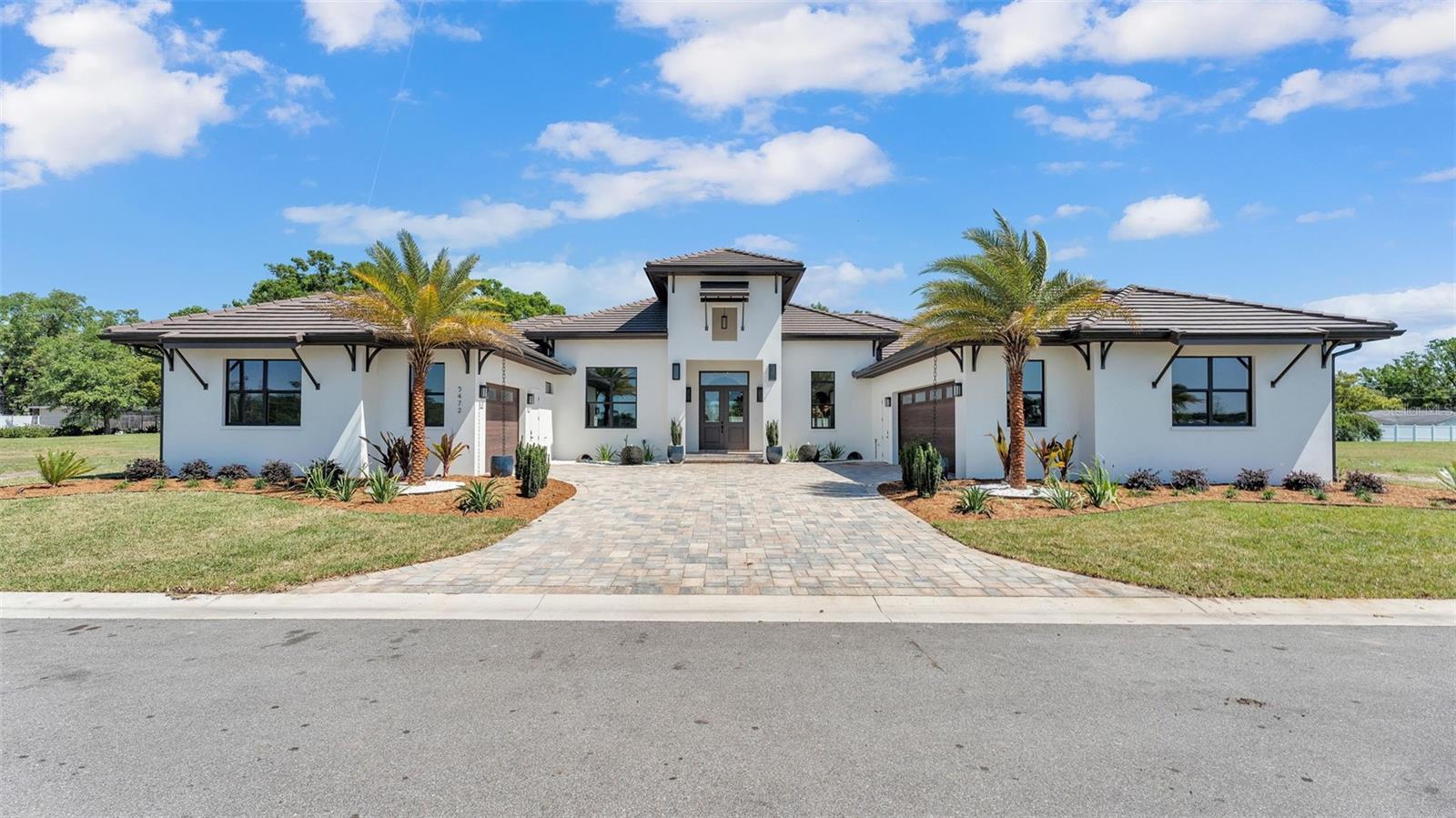 Are you dreaming of a turn-key custom-built home, that is as comfortable as it is luxurious in Central Florida? Here's a BRAND NEW property featuring designer finishes, quality craftsmanship, an amazing outdoor oasis with a custom heated salt water pool with Pebbletec finish, sun shelf, huge infinity edge spa, travertine deck, screened lanai, fully loaded outdoor kitchen, modern landscaping including lighting, water & fire features… PLUS Lake access with your own private boat slip! Welcome to 5472 Shoreview Drive in Lakeland, FL... This award winning model home was the 2025 Polk County Builder's Association Showcase Home and provides over 3,500 square feet of living space (over 5,300 under roof) and every inch has been thoughtfully designed and constructed by the team at Joe Goldsmith Construction in collaboration with Rachel Reynolds Design, Dreamscapes Outdoor Living & Design, Goldsmith Pools and other top vendors. The floor-plan flows beautifully with two primary suites, two additional bedrooms, four full bathrooms, an office with hidden closet and seamless entertaining space. You'll enjoy every modern convenience including tile roof, double ovens, propane cooktop, prep sink, coffee bar, wine fridge, double dishwashers, mud room, two laundry rooms, built-in closets, walk-in pantry, high-end light fixtures, 3 car garages, two gas water heaters and 2 HVAC units. The finishes were inspired by a Modern Hacienda/Modern Mediterranean aesthetic with stunning wood beams, barrel vault details, Artisan carpentry, tile mosaics, color drenching, wall paper, tongue and groove ceilings, solid wood cabinets, quartz and granite counters, built in niches, etc. Every detail is exquisite! This is the first home completed in this highly anticipated gated community with only 11 total lots. Water’s Edge at Lake Gibson offers the Florida lifestyle you’ve been looking for in a Central location, close to Interstate 4, medical facilities, three minutes from Publix, shopping, restaurants and area attractions. If you'd like to completely customize your own build in the neighborhood, there are 9 lots left (all with lake access and several with direct water frontage). You'll want to see it in person to appreciate every element, so contact us today to set up your private tour!