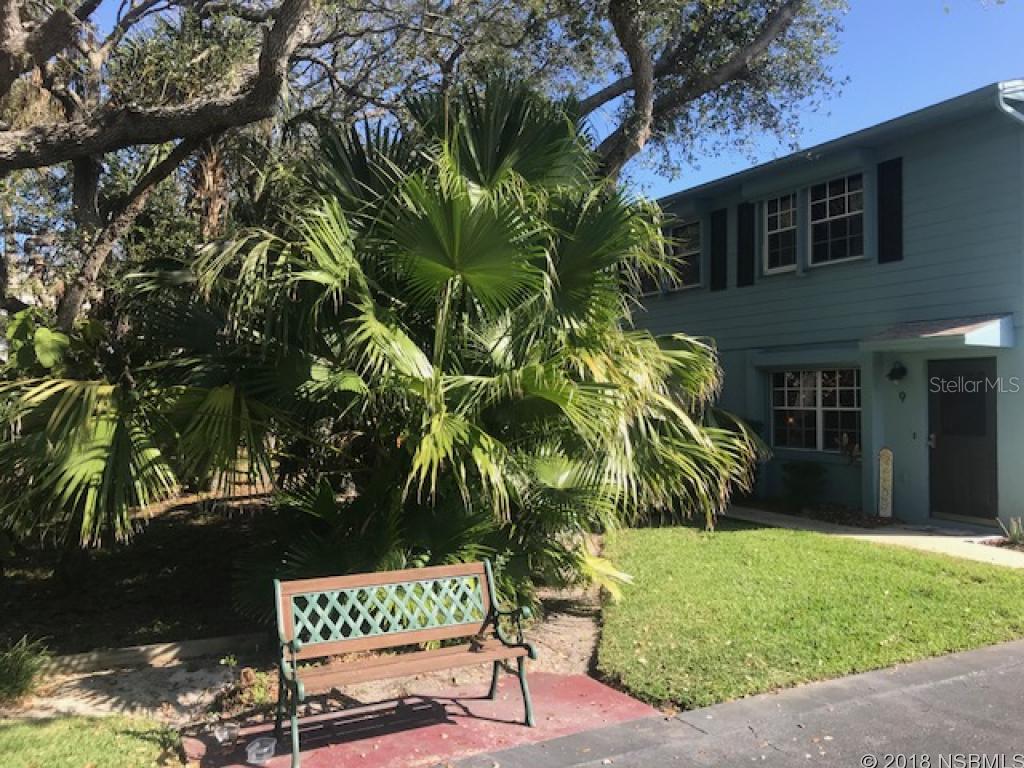 Peaceful and hidden. Beachside and urban. THIS PROPERTY IS UNLIKE ANYTHING YOU'VE SEEN BEACHSIDE. This 2/1.5 townhouse with interioratrium off kitchen, oversized garage and southern facing upper deck is new to the market. Come see before this gets photographed. Location,location, location.... like New Smyrna Beach but not necessarily oceanfront? The setting of this home is "urban park-like". The 11 unit complex just off of Flagler Ave is the hidden garden you are looking for. Downstairs: front door to the north, garage to the south, living room, half bath, indoor laundry and atrium off kitchen. Upstairs: Two bedrooms, full bath, walk up attic and southern exposure deck. Hurricane rated garage door and hurricane shutters with electric motors & manual crank option. Tile throughout 1st floor. New hot water tank Feb. 2018. New dishwasher Feb. 2018.Updated from original: Corian solid surface kitchen counter, all wood kitchen cabinets, side by side fridge, over range microwave, double hungdoors with built in blinds, ceiling fans, all wood louvered doors w/ brass hardware, slider in master bedroom, retractable ladder to attic. Outside the shady front door is mature landscaping with no neighbors in sight. Out the back is an oversized garage and driveway with spare parking. Garagehas room for a car and more. HOA maintains exterior and building insurance. No leasing restrictions per HOA or local zoning rules. So manypossibilities. The building has just three units. ;Water: City