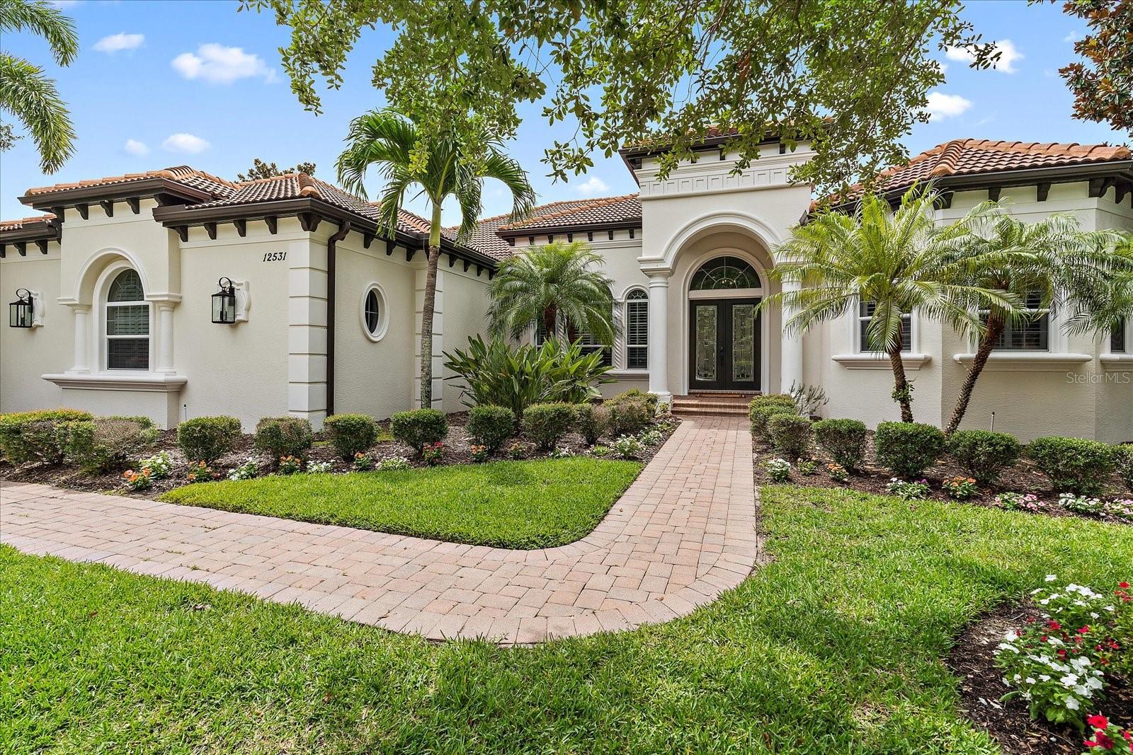 Welcome to 12531 Highfield Circle, a masterpiece of modern elegance located in the heart of Lakewood Ranch, behind the gates of Lakewood Ranch Country Club. This exceptional residence, boasting 4 bedrooms, 4 1/2 bathrooms, and a 3-car side-load garage, offers a blend of luxury, comfort, and tasteful living, all thoughtfully positioned on a half-acre parcel with desirable south facing backyard. Step inside to discover the perfect fusion of style and functionality. The bathrooms have been meticulously updated, providing a spa-like experience with new decorous lighting, porclain tile and quartz countertops.  The primary wing offers generous size study with built-ins, sunroom with large sklylight and large bedroom with french door to the lanai and two walk-in closets.  The primary bathroom is stunning with a large walk-in shower with dual shower heads, hand held sprayer, linear drains, marble flooring and lighted niche for soaps and shampoos.  The free standing tub, private water closet and dual sinks complete this zen oasis. The first floor of this 5232 square foot residence, features new engineered hardwood floors, creating a seamless and contemporary ambiance throughout. The large planks are timeless and complement the soaring ceilings with exquisite molding. The heart of this home is the gourmet kitchen, equipped with top-of-the-line appliances, including a full-size GE Monogram refrigerator and freezer. The sleek design and high-end finishes make this kitchen a chef's delight, perfect for culinary creations and entertaining with the center island serving as a focal point with bar seating and extra cabinetry for storage.  The new quartz counters glisten and marble backsplash compliments the newly painted wood cabinets with new hardware and new dishwasher. The cooktop features natural gas and has an exhaust hood.  The living spaces have been thoughtfully designed with a gas fireplace in the two story Living Room and a new rock feature wall with horizontal fireplace in the family room providing warmth and a touch of modern sophistication. This cozy space is perfect for intimate gatherings or relaxing by the fire and is adorned with plantation shutters, built in desk and beverage refrigerator.  Bedroom two is en-suite and extra large with plenty of space for a addition tv area, library or studio!  Bedroom #3 is located in the rear of the home with sliding doors to the pool and spa and access to the pool bath which was fully remodeled and tastefully done.  Travel up the stairs to the large bonus room with wet bar, cabinetry, and wood flooring!  Enjoy nights around the pool table or movie night with desert on the balcony overlooking the pool and spa!  The fourth bedroom is tucked away on the second floor and boasts a massive walk-in closet!  The full bathroom on the second floor is elegant and timeless and serves bedroom four as well as the bonus room.  The backyard is a dream come true with nearly a half acre of lush grass and mature trees and landscaping. Lakewood Ranch Country Club is renowned for its world-class golf courses, providing members with the opportunity to live in the lap of luxury amidst lush, meticulously manicured landscapes. Whether you're an avid golfer or simply appreciate the scenic beauty, this community offers an unparalleled living experience with access to a host of exceptional amenities. This homes is minutes to vibrant shops and restaurants at Main St. and Waterside. Make 12531 Highfield Circle your forever home!