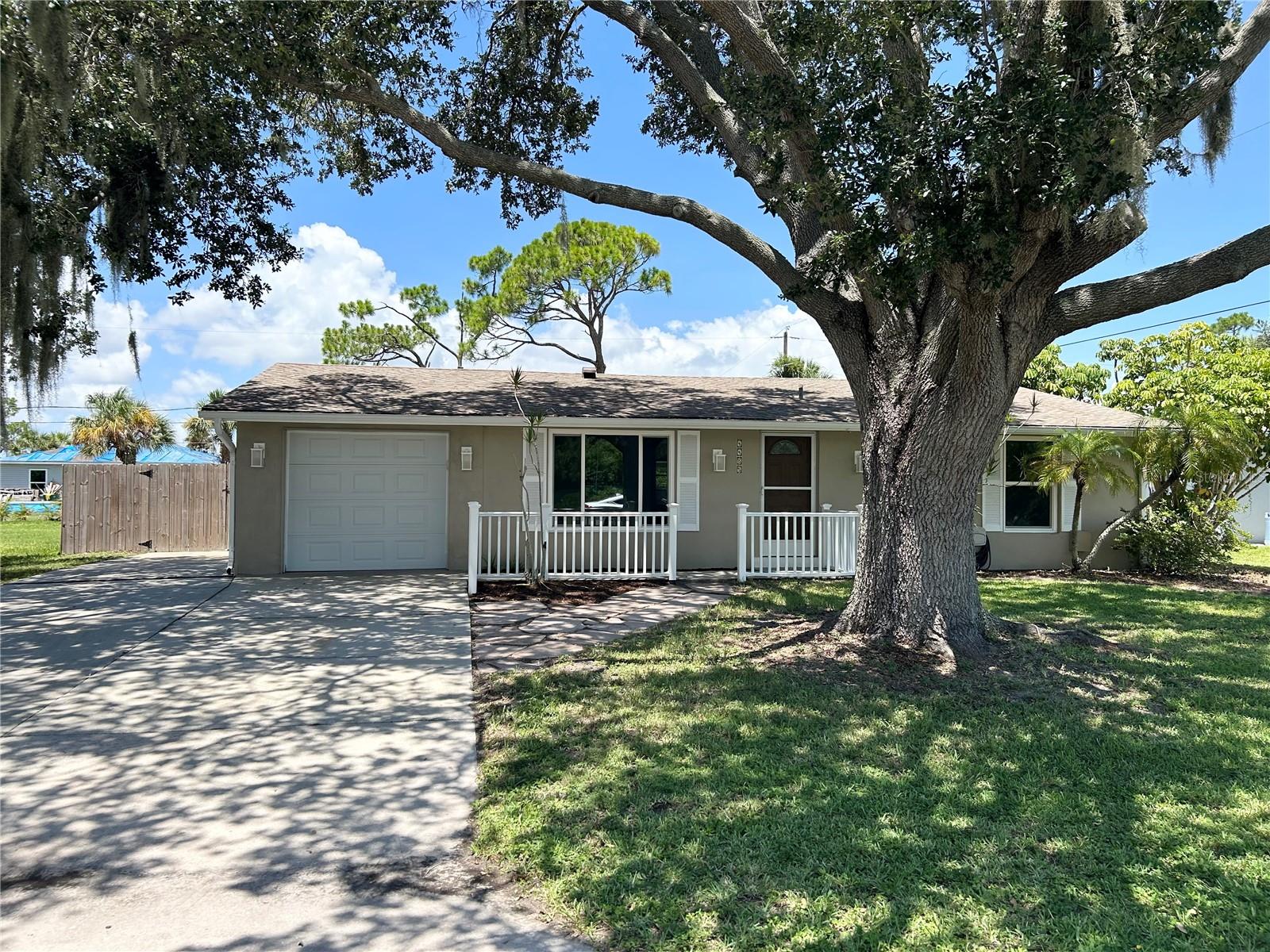 Located in a Quiet and desirable area of Port Charlotte. This property features many UPDATES throughout the home offering COMFORT, Style, and Easy maintenance.  Beautiful Oak tree shades the Front yard. This home is meant for Florida LIFESTYLE living.  Front Entry into an OPEN Floor plan.  Begin in the BRIGHT, spacious Living Room. Living AREA flows to the Dining and Kitchen, then the Large FAMILY/flex room with plenty of natural Light, creates a seamless flow between indoor and outdoor living spaces There is a Large UTILITY room with A/C off the FAMILY Room.  It holds an 'Extra' refrigerator along with the Washer & Dryer, many storage cabinets along with a Big storage closet.  Large SLIDER from Family Room to full length COVERED LANAI & beautiful POOL with cage.  Private, Peaceful FENCED backyard.  The DINING area leads into KITCHEN with all Appliances and a BREAKFAST bar.  EXTRA Under sink - Is Garbage Disposal and Reverse osmosis water system.  Kitchen has Side Door to Garage with lots of shelves & side outdoor EXIT Door.   Hallway to BR’s.  BR2, Hall BATH with tub & Linen CLOSET.  Walk in to Master Bedroom En-suite with TWO Large CLOSETS and it’s own SLIDER out to the Comfortable COVERED Lanai, pool & private yard.  En-suite BATH has a LARGE seated SHOWER stall, vanity area.  As you walk thru notice this home is Refreshed with MANY UPDATES.  When you step in you will know offering comfort, style, and easy maintenance. The spacious Family Florida room and lanai area are perfect for relaxing or entertaining while enjoying the Florida lifestyle.  All Tastefully UPDATED with newly installed LVP flooring and baseboards, light Fixtures, ceiling fans all around. New POOL CAGE 2023, Water Heater 2023, Roof 2022, AC 2019, Garage Door & Impact Windows 2019, Elec Main PANEL 2019.  Private Fenced backyard with 19x17 stone patio.  2 sliders to the Large lanai Covered, screened area for relaxing with family & friends.  THEN the GORGEOUS POOL with pool cage! There is also an Extra PARKING Pad off the main driveway.  Conveniently located near shopping, dining, parks, and everyday amenities. Two photos are staged.  All DIMENSIONS are Approximate and should be verified by buyer/buyers agent.