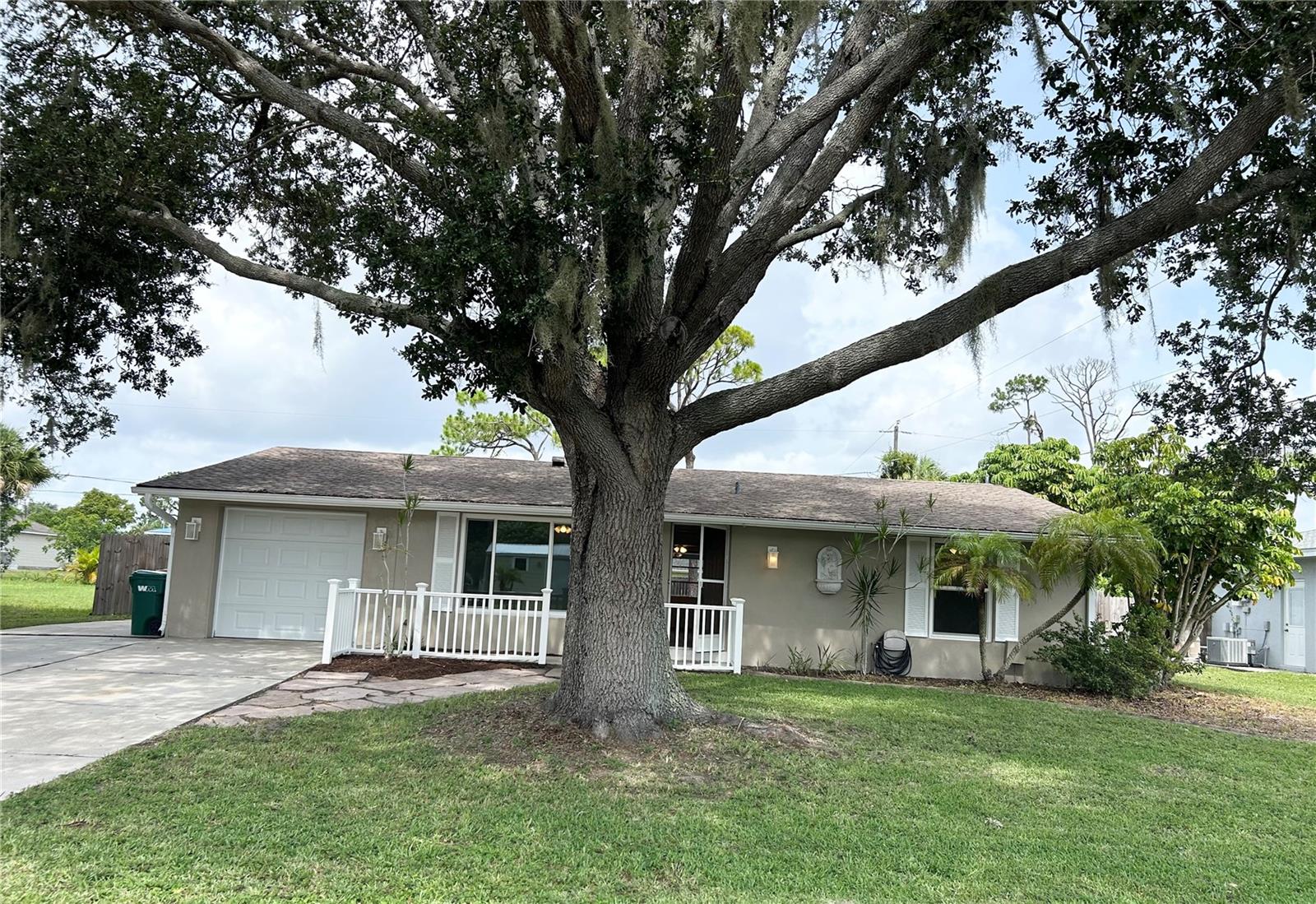 Located in a Quiet and desirable area of Port Charlotte. This property features many UPDATES throughout the home offering COMFORT, Style, and Easy maintenance.  Beautiful Oak tree shades the Front yard. This home is meant for Florida LIFESTYLE living.  Front Entry into an OPEN Floor plan.  Begin in the BRIGHT, spacious Living Room. Living AREA flows to the Dining and Kitchen, then the Large FAMILY/flex room with plenty of natural Light, creates a seamless flow between indoor and outdoor living spaces There is a Large UTILITY room with A/C off the FAMILY Room.  It holds an 'Extra' refrigerator along with the Washer & Dryer, many storage cabinets along with a Big storage closet.  Large SLIDER from Family Room to full length COVERED LANAI & beautiful POOL with cage.  Private, Peaceful FENCED backyard.  The DINING area leads into KITCHEN with all Appliances and a BREAKFAST bar.  EXTRA Under sink - Is Garbage Disposal and Reverse osmosis water system.  Kitchen has Side Door to Garage with lots of shelves & side outdoor EXIT Door.   Hallway to BR’s.  BR2, Hall BATH with tub & Linen CLOSET.  Walk in to Master Bedroom En-suite with TWO Large CLOSETS and it’s own SLIDER out to the Comfortable COVERED Lanai, pool & private yard.  En-suite BATH has a LARGE seated SHOWER stall, vanity area.  As you walk thru notice this home is Refreshed with MANY UPDATES.  When you step in you will know offering comfort, style, and easy maintenance. The spacious Family Florida room and lanai area are perfect for relaxing or entertaining while enjoying the Florida lifestyle.  All Tastefully UPDATED with newly installed LVP flooring and baseboards, light Fixtures, ceiling fans all around. New POOL CAGE 2023, Water Heater 2023, Roof 2022, AC 2019, Garage Door & Impact Windows 2019, Elec Main PANEL 2019.  Private Fenced backyard with 19x17 stone patio.  2 sliders to the Large lanai Covered, screened area for relaxing with family & friends.  THEN the GORGEOUS POOL with pool cage! There is also an Extra PARKING Pad off the main driveway.  Conveniently located near shopping, dining, parks, and everyday amenities. All DIMENSIONS are Approximate and should be verified by buyer/buyers agent.