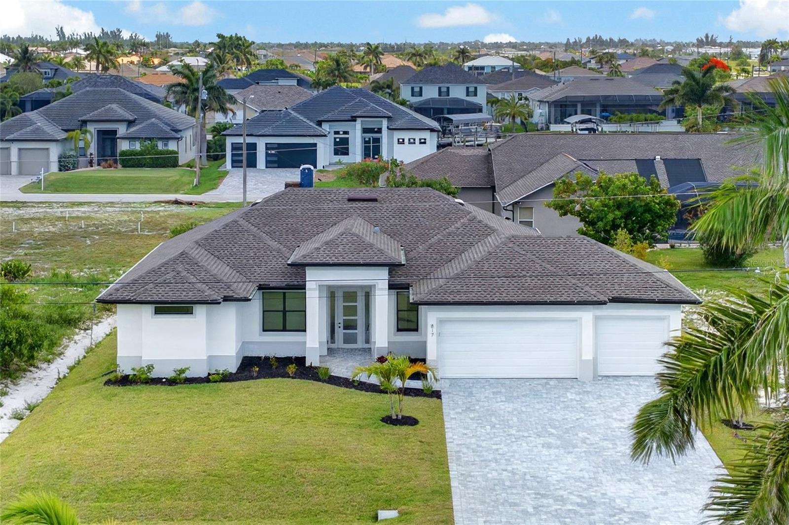 WELCOME TO YOUR PRIVATE CAPE CORAL RETREAT — a BEAUTIFULLY DESIGNED NEWER CONSTRUCTION POOL HOME perfectly positioned in one of Northwest Cape Coral’s fastest-growing and most desirable areas. Surrounded by stunning Gulf-access homes and offering NO HOA restrictions, this property delivers the ideal blend of MODERN LUXURY, FUNCTIONALITY, and the laid-back Florida lifestyle buyers are searching for.

Built with both comfort and style in mind, this spacious 3 BEDROOM + BONUS ROOM/DEN, 2 BATHROOM home offers an OPEN-CONCEPT FLOORPLAN filled with natural light and elevated finishes throughout. From the moment you step inside, you'll notice the SOARING TRAY CEILINGS, elegant modern design, and seamless flow between the main living spaces — creating the perfect setting for both entertaining and everyday living.

The chef-inspired kitchen features STAINLESS STEEL APPLIANCES, SOLID SURFACE COUNTERTOPS, ample cabinetry, and an oversized layout designed to keep everyone connected. The SPLIT-BEDROOM FLOORPLAN provides added privacy, while the additional BONUS ROOM/DEN offers flexibility for a home office, media room, gym, playroom, or guest space.

The spacious PRIMARY SUITE serves as a true retreat with DUAL WALK-IN CLOSETS and a beautifully appointed spa-style ensuite bathroom featuring DUAL VANITIES, a GLASS-ENCLOSED SHOWER, and a relaxing SOAKING TUB.

Step outside and enjoy your own private backyard oasis complete with a SPARKLING POOL, PAVER POOL DECK with SCREEN ENCLOSURE, and plenty of room to relax or entertain year-round. Additional upgrades include HURRICANE SHUTTERS, ENERGY-EFFICIENT CONSTRUCTION, a PAVER DRIVEWAY, and an OVERSIZED 3-CAR GARAGE offering abundant storage for vehicles, toys, or workshop space.

Conveniently located WEST OF BURNT STORE ROAD near Coral Oaks Golf Course, Burnt Store Marina, dining, shopping, and public boat ramps, this home offers easy access to everything Southwest Florida has to offer while still providing a peaceful residential setting.

If you’ve been searching for a MOVE-IN READY POOL HOME with upgraded finishes, modern construction, and an unbeatable Cape Coral location — this is the one.