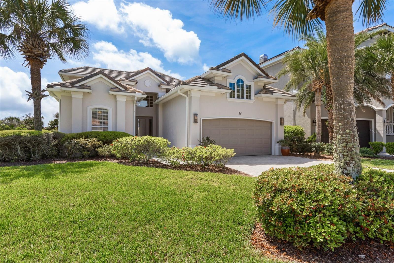 Experience coastal living at its finest in this beautifully updated home just steps from the ocean. Located in the coveted Ocean Hammock community, this spacious residence offers a bright, open layout designed for effortless indoor–outdoor living. 
Inside, the home features high ceilings, tray ceilings, abundant natural light, fresh interior & exterior paint, tile & wood floors, and elegant finishes throughout. The gourmet kitchen boasts modern high-end stainless steel appliances, wine cooler, ample cabinet space, and a large island ideal for gathering. The living areas flow seamlessly to the huge private screened lanai, creating a true Florida lifestyle experience.
The primary suite offers a peaceful retreat with a spa-inspired soaking tub and walk-in shower. The additional guest rooms, 2 downstairs and 2 upstairs, provide comfort and privacy for family and visitors or versatile spaces ideal for an office, media room, or fitness area. BRAND NEW ROOF June 2026 (Not in Photos)
Located within a gated, golf-cart-friendly community with easy access to the beach and world-class amenities, this home is ready for you to move in and find that coastal comfort - A Rare Opportunity at this Price!
