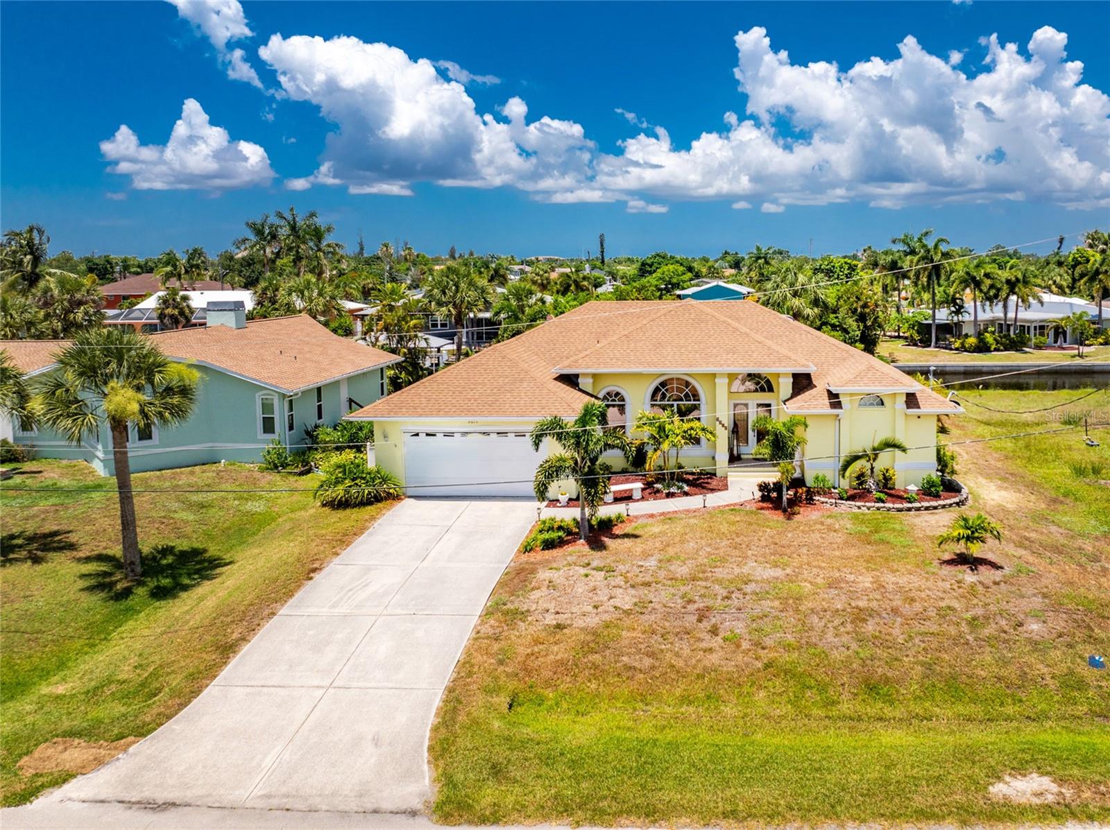 Located in Charlotte Park, this home has a backyard that leads to Charlotte Harbor and the Gulf of Mexico! This waterfront salt-water pool home has three bedrooms, two bathrooms and a 2-car garage with excellent elevation. No flooding or hurricane damage. This spacious home has tile flooring throughout the main living rooms, luxury vinal in bedrooms, an open floor plan, cathedral ceilings, ceiling fans, and lots of privacy! The kitchen features corian countertops, lots of storage space, a pantry, a built-in desk, a breakfast bar, a 2-year-old stainless refrigerator and a spacious dining area that overlooks the water. The huge primary bedroom has lanai access and 2 walk-in closets.  His and her sinks with built-in vanities and separate shower and tub. Also, the additional bedrooms are on a split floor plan, providing lots of privacy. They both feature ceiling fans and walk-in closets. A four-panel pocketing slider leads out to a large lanai with a heated saltwater pool. The pool heater was replaced in2023 and the pool pump in 2024. The cool deck surface has been recently repainted, and the cage got new screws and screening in 2023. The hot water heater was replaced in 2025.This home is in a quiet neighborhood, minutes from downtown Punta Gorda with shopping, dining, waterfront parks, walking and biking paths, art galleries, Fishermen's Village, Charlotte Harbor Event Center and weekend farmer’s markets. Sellers will most likely need a short term leaseback.
