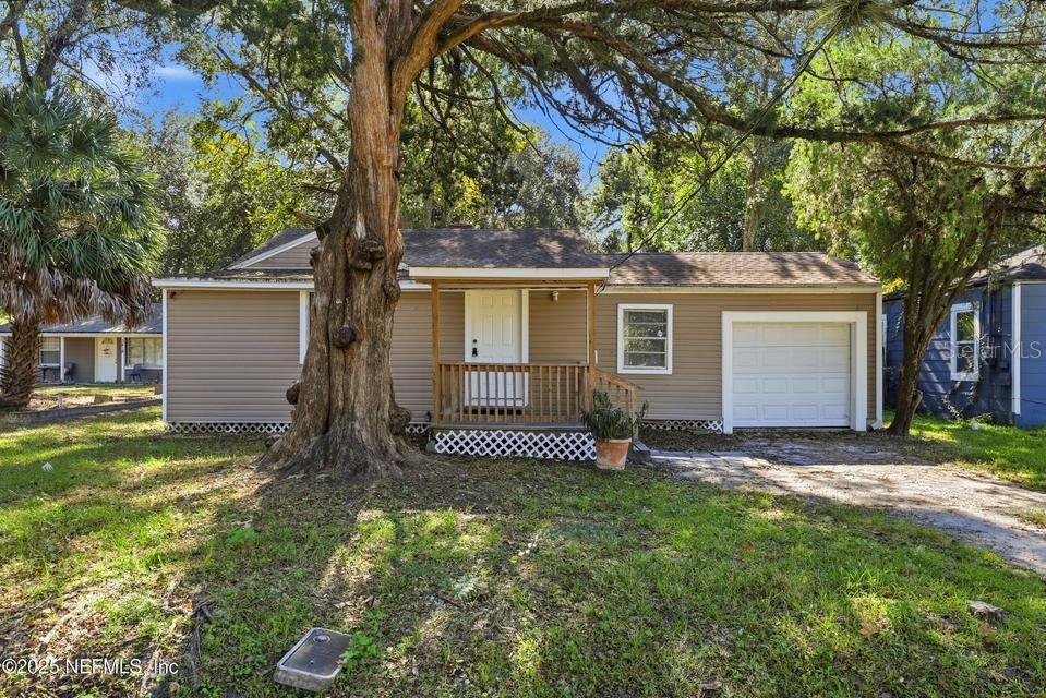 Back on market the day before closing at no fault to seller! Charming and move-in ready, this 3-bedroom, 1-bath home features laminate and tile flooring throughout--no carpet! The updated interior provides a comfortable, modern living space, while the large yard and covered back deck offr plenty of outdoor enjoyment. Nestled on a quiet street, the home combines comfort and functionality, with the garage thoughtfully converted into a versatile room perfect for an office, playroom, or extra living space. Relax on the covered front or rear porches while enjoying your morning coffee or evening downtime. Conveniently located near schools, shopping, and major roads, this home offers the ideal balance of peaceful living with easy city access. Don't miss this opportunity! Seller is open to open to seller financing/sub to financing offers!