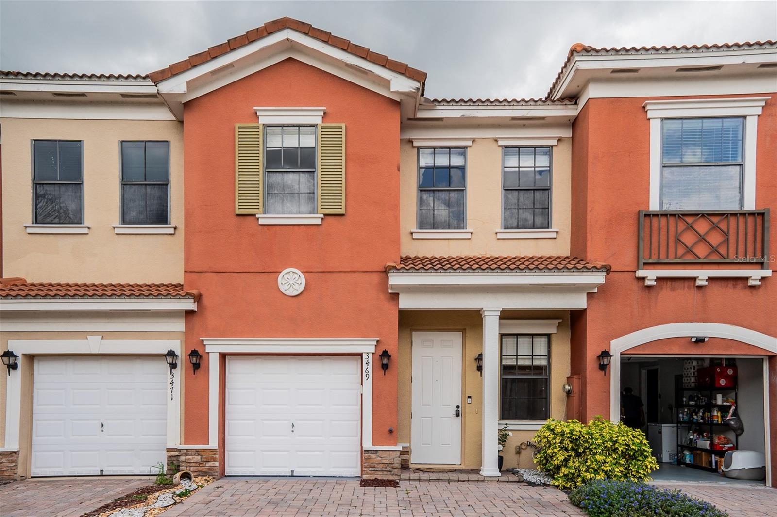 Welcome home to this beautifully maintained 3-bedroom, 2.5-bath townhome in the gated, waterfront community of Portofino Vista in St. Cloud—offered below recent comparable sales for a quick, clean sale. Set among the community's tranquil ponds and lakes, this two-story Mediterranean-style residence pairs low-maintenance living with move-in-ready updates. Inside, an open-concept main level flows from the foyer into the living and dining areas beneath designer accent walls and a stacked-stone feature wall, all finished with easy-care tile flooring and a stylish dining chandelier. The updated kitchen is the heart of the home, with crisp white shaker cabinetry, granite countertops, a glass mosaic backsplash, a full appliance suite, and a breakfast bar perfect for casual meals. Sliding glass doors open to a private, fully fenced backyard with a paver patio—ideal for relaxing or entertaining. A chic powder room with a modern floating vanity and a one-car garage complete the first floor. Upstairs, plush carpet leads to a generous primary suite featuring a tray ceiling, peaceful treetop views, and a spa-like en-suite bath with a garden soaking tub, separate tiled glass shower, dual vanities, and a private water closet. Two additional bedrooms with ceiling fans share a well-appointed hall bath with a glass-enclosed tub/shower. Recent updates include a 2024 A/C system for added peace of mind. Residents enjoy resort-style amenities including a clubhouse, sparkling community pool, and ample guest parking. Ideally located minutes from Florida's Turnpike, Lake Nona Medical City, Orlando International Airport, and St. Cloud's lakefront, parks, shopping, and dining - with Walmart just six minutes away. Priced to sell and ready for its next owner - schedule your private showing today!