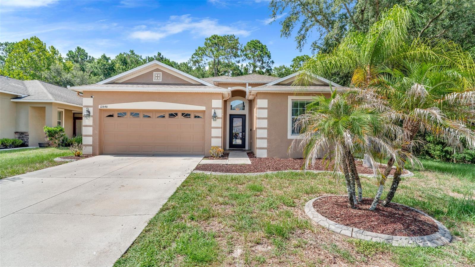 Welcome to this beautifully maintained 4-bedroom, 3 bath home located in the desirable The Verandahs community in Hudson. Offering a spacious open-concept floor plan, this home is designed for both comfortable everyday living and effortless entertaining. The kitchen features ample cabinet and counter space, a breakfast bar, and opens seamlessly to the dining and living areas. The generous primary suite offers a walk-in closet and an en-suite bath with dual vanities and a walk-in shower. Three additional bedrooms provide flexibility for family, guests, or a home office. Step outside to enjoy the covered lanai overlooking the backyard perfect for relaxing. Additional features include a two-car garage, an indoor laundry room, and plenty of storage throughout. Residents of The Verandahs enjoy community amenities including a clubhouse, resort-style pool, fitness center, playground, walking trails, and scenic ponds. Conveniently located near SR 52 and the Suncoast Parkway, this home offers easy access to Tampa, shopping, restaurants, schools, medical facilities, and the Gulf Coast beaches. Motivated seller! Schedule your private showing today and make this wonderful home yours.