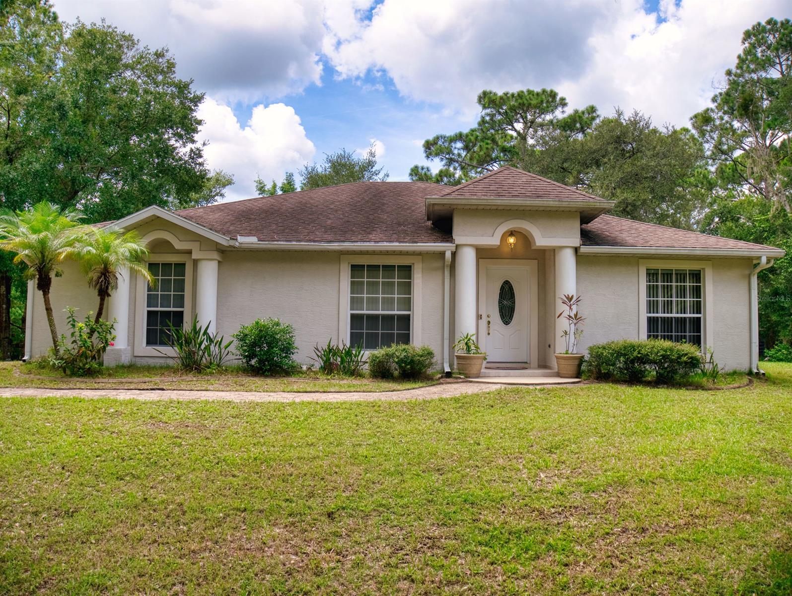 Rural paradise in convenient New Smyrna location with peaceful nature views.  Welcome to 2218 Turnbull Bay.  This concrete block home offers 3 bedrooms and 2.5 baths and is nestled atop a slice of over 2 acres of property and surrounded by a canopy of mature native trees.  Its spacious grounds include a lovely stone pathway to the front door, concrete yard curbing and plenty of room to park your boat, RV, ATV’s or most any other recreational vehicles.  Constructed of concrete block, this homes interior boasts vaulted ceilings, built-in shelves and decorative ceramic tile w/tumble stone design in the entryway. Accent arches and columns add to the architectural beauty of this custom home.  The kitchen is the heart of the home and boasts an easy to work in design, plenty of storage space and a wraparound breakfast bar adorned with wanes coating large enough to sit 4 comfortably which overlooks the bright open living area.  In the master bedroom, you find a relaxing retreat with master bath features including double sink, separate water closet, walk in shower and a corner garden tub perfect for soaking your cares away. From sliding glass doors from the living area, you and your loved ones will enjoy bbq’s, holidays, or just relaxing on the covered 10x18 lanai.  This peaceful area overlooks the spacious yard where you can create your very own relaxing oasis.  Other features include a 2 car garage, separate family room, formal dining area and indoor laundry.  All conveniently located near to local golf courses, NSB Sports Complex and still only a short trip to a day at the beach! Lots of Potential. ;Water: City