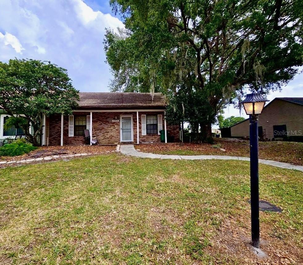 Welcome to Whispering Oaks Estates, where maintenance-free living offers comfort and convenience! This charming villa offers a thoughtfully designed split bedroom floor plan with 1520 square feet of living space. Enjoy a Light, Bright eat-in kitchen with an open pass thru to the dining room area boasting volume ceilings, OPEN to the spacious great room featuring a brick wood-burning fireplace, mirrored bar and closet for added storage. This villa features an expansive 10 x 29 enclosed lanai overlooking greenspace perfect for relaxing with no rear neighbors! There is also a flex space Florida room area between the great room and lanai which would make a perfect home office, fitness area, sitting/reading nook or gameroom. Attached golf cart parking/storage shed/workshop also offers additional storage! Updates include Luxury vinyl plank floors in common areas, Roof replaced in 2019, some siding and windows were updated. Also a Solar tube was added for natural light plus Appliances are included. With low annual HOA fees and no CDD fees, this villa is ideally located just north of State Road 50 off US 301, providing easy access to Brooksville, Historic Dade City, Wesley Chapel, Orlando, Ocala, Tampa, Airport and Beaches! Available both For Sale or For Lease. CALL TODAY!