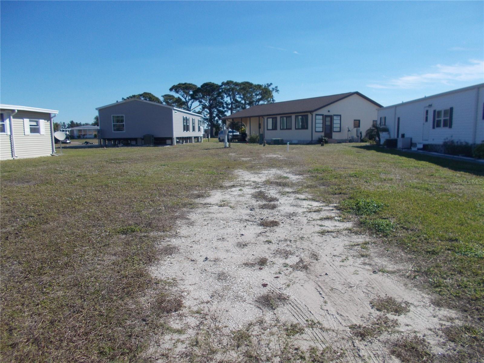 Vacant land in sought after 55+ Gated Community of Holiday Park and in the Pet Section. The land is located on Anapa Court which is a cul-de-sac.  This lot is 4225 square feet. In Holiday Park you own the land with a deed and the maintenance fee of $2340.00 a year ($195.00 a month) is included in your taxes.  Holiday Park offers many amenities including 2 Pools, Tennis Courts, Pickleball, Bocci, Shuffleboard, Laundry, Library, Horseshoes, Bingo, plus other card games, Fitness Room, and so much more.  This home has been pulled off and the electric and water are in place.  This is a perfect place for your new manufactured home. Come and see!