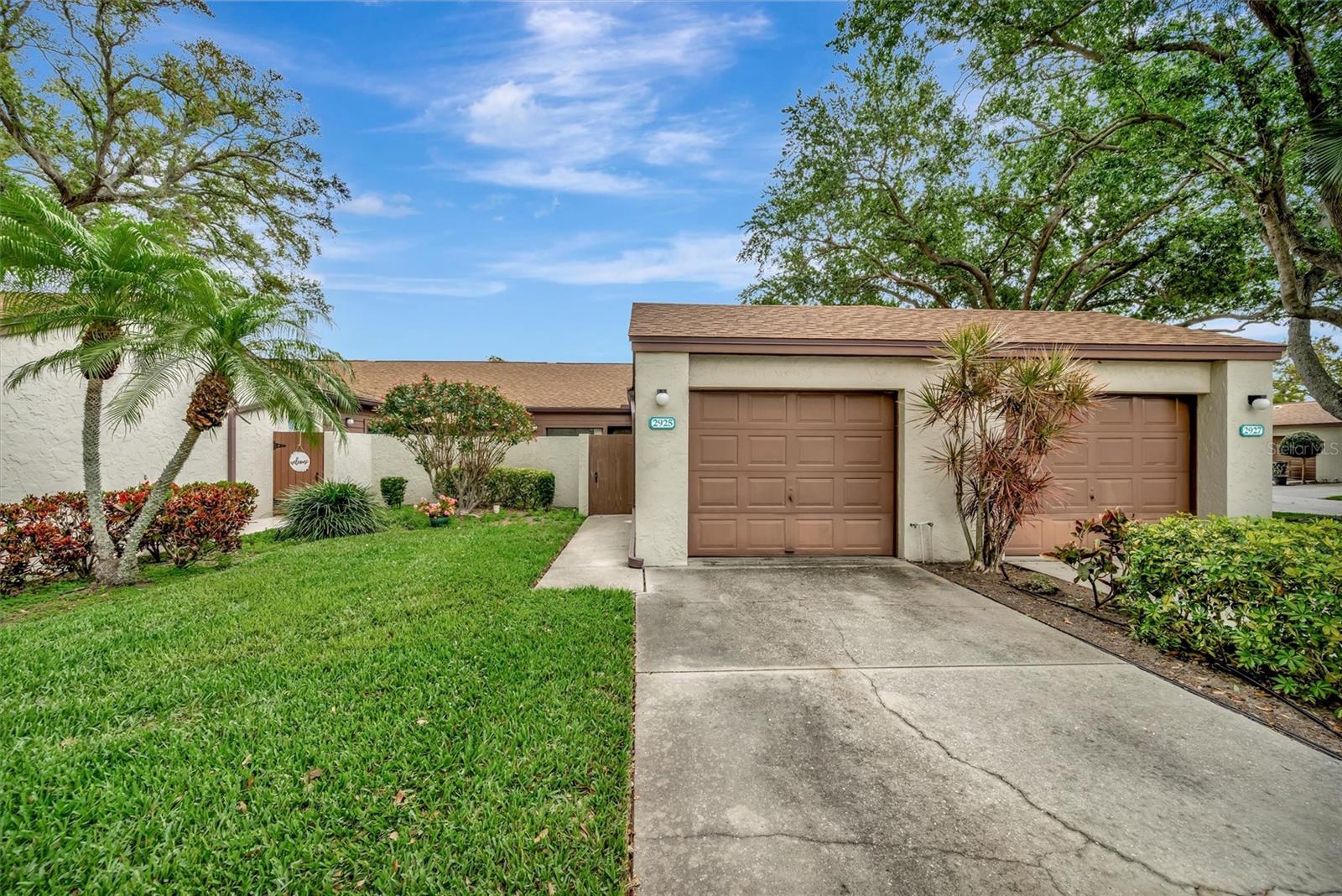 Welcome to 2925 Park Lake Drive in Forty Three West Oaks, a villa community in the heart of West Bradenton. This 2-bedroom, 2-bath home offers vaulted ceilings, a spacious driveway, nearby guest parking, and a practical floor plan with plenty of potential to make it your own. The great room opens to a screened lanai through a wall of glass sliders, creating additional living space and a seamless connection to the outdoors. The lanai can also be accessed from the second bedroom and features a dedicated laundry room just off to the side. Beyond the lanai, the fenced courtyard is full of potential and ready to be transformed into your own private retreat. Both bedrooms feature en-suite bath access. Pocketing doors to the second en-suite bedroom provide flexibility to use the space as a guest room, home office, den, or additional living area. The one-car garage, spacious driveway, and nearby guest parking provide added convenience for homeowners and visitors alike. Residents of Forty Three West Oaks enjoy access to a community pool, tennis and pickleball courts, shuffleboard, and clubhouse. Conveniently located near shopping, dining, medical facilities, Robinson Preserve, GT Bray Park, and the beaches of Anna Maria Island.