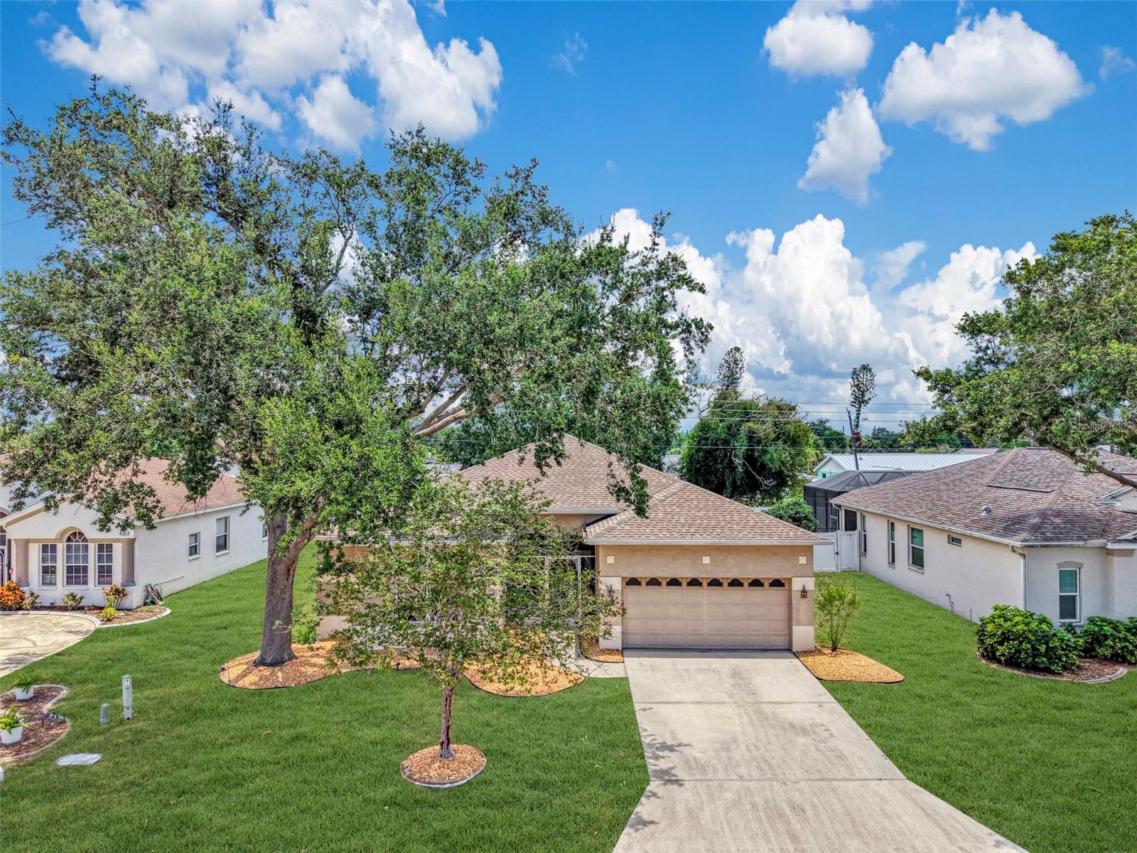 WOODMERE LAKES – UPGRADED 4 BEDROOM + DEN POOL HOME WITH 2022 SALTWATER POOL, SPA, AND TIKI BAR! Welcome to one of the most extensively upgraded homes in sought-after Woodmere Lakes. This 4-bedroom, 2-bath home with a full-size den/office combines major recent updates with an unbeatable Venice location. The centerpiece is the saltwater heated pool and spa with waterfall, completed in 2022 with brand new everything, plus a custom tiki bar built the same year. The fully fenced backyard creates a private retreat ideal for entertaining, pets, or relaxing. The list of documented upgrades is impressive. Porcelain tile flooring was installed throughout in 2021. Granite countertops were added to the kitchen, both bathrooms, and the fireplace in 2019. The walls, trim, and living room and kitchen ceilings were completely repainted in 2026, and brand new hurricane impact front doors were installed in May 2026. The oversized kitchen features a large breakfast bar, tiled backsplash, touch-activated faucet, a Samsung range with built-in air fryer, and a 2019 Samsung Smart Refrigerator with built-in tablet. The open great room offers crown molding, a recently installed ceiling fan, and a decorative fireplace that can easily be converted to electric. The split-bedroom floor plan provides privacy for everyone, and each bathroom includes a new Bluetooth speaker, fan, and light combination. Oversized windows across the rear of the home fill the living spaces with natural light and offer beautiful views of the pool and lanai. Mechanical and smart home updates add real peace of mind: newer roof (2019), new water heater (2024), two UV mold-prevention lights installed in the A/C system in 2025, Google Nest thermostat, electronic door lock, and a Tesla EV charging station in the garage. The home also includes a large inside laundry room with full-size washer and dryer, garage shelving, and low-maintenance landscaping with decorative river rock and curbing. The location is a true walk-to-everything spot. Woodmere Park, the dog park, Jacaranda Public Library, Target, Publix, Staples, Floor & Decor, and numerous popular restaurants are all within walking distance. Historic Downtown Venice, boutique shopping, waterfront dining, and Venice Beach are just 5 minutes away. Best of all, the Woodmere Lakes HOA is only $860 per YEAR, one of the lowest HOA fees in Venice. This meticulously maintained home delivers the complete package: space, upgrades, location, and value. Schedule your private showing today!