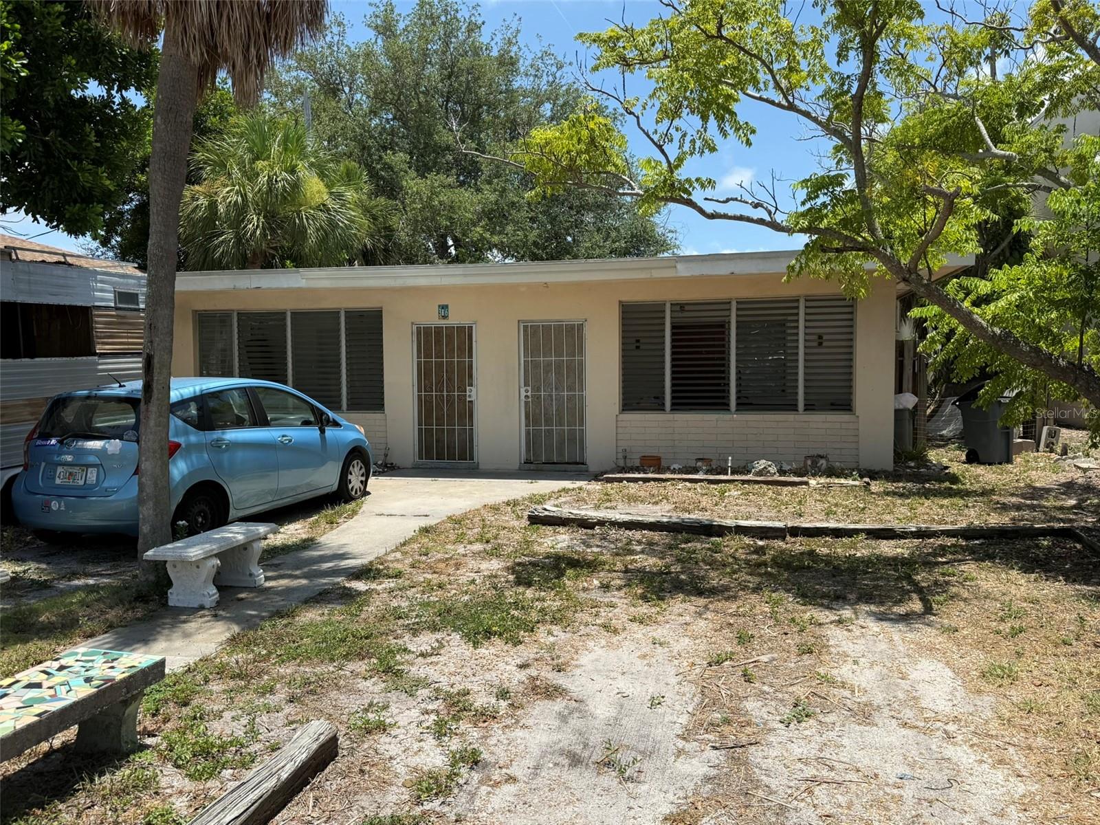 This mid-century, masonry duplex sits in one of St. Pete Beach's most walkable pockets — a 3-4 minute stroll to Corey Avenue's shops, restaurants, and long-running Sunday Market, with Upham Beach's sand and Gulf water an easy bike ride or half-mile walk beyond. Across the street sits Horan Park and the city's family aquatic center, putting a beautifully maintained pool and waterfront green space just steps away — no private pool to maintain, just walk over and use theirs ... Original terrazzo floors run throughout, a genuine mid-century touch ... Two 1BR/1BA units plus a detached second structure occupy a 5,375 sf lot, with recent updates including 2018 central AC, new ductless mini-splits, and a new electric water heater ... Beyond those mechanical updates, this is a value-add opportunity — cosmetically and structurally, it's being offered as-is, priced to reflect the work ahead for the right buyer ...  The parcel is zoned TC-1, and according to the city's schedule of permitted uses, this district allows for a range of neighborhood-commercial uses — office, retail, take-out and full-service dining, artist studios and galleries, printing/copying, and commercial kitchens among them, several requiring no conditional use hearing ... Buyers interested in exploring any change of use are encouraged to confirm scope and requirements directly with the City of St. Pete Beach Planning & Zoning Division as part of their due diligence ... The property also holds a distinctive spot on the block: the only residential use remaining, flanked by a retail building and a medical office, with a gas station just behind — a walkable, livable duplex today, with real long-term flexibility built into its zoning! HURRY on this rare and unique opportunity ... shown strictly by appointment ...