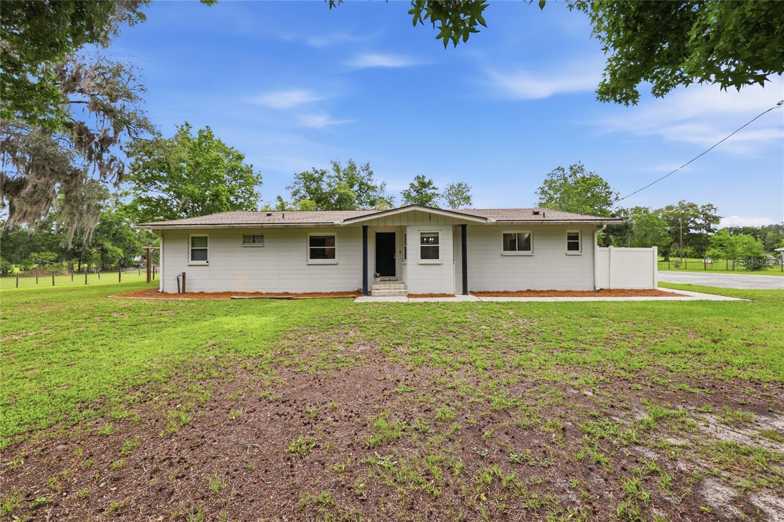 Completely renovated and move-in ready, this beautiful home sits on 4.7 acres in a highly desirable location on SW 75th Street, offering convenient access to the University of Florida, UF Health Shands Hospital, shopping, dining, and more. The home features a fully remodeled kitchen with granite countertops, new cabinetry, stainless steel appliances, and a gas range and oven. Both bathrooms have been tastefully updated, and additional improvements include refreshed walls and ceilings, updated blinds, a newer roof, and a new exterior A/C unit.Outside, enjoy a resurfaced pool with new tile, creating the perfect setting for relaxing or entertaining. The home is serviced by well and septic and includes a tankless water heater.The property offers excellent accessibility with frontage on both SW 75th Street and SW 77th Street. According to the seller, the property may allow for construction of an approximately 1,700-square-foot accessory dwelling unit (ADU), providing potential for multigenerational living, guest accommodations, or future income opportunities. The seller also states that, after five years of ownership, the property may be eligible to be divided and conveyed to an immediate family member, as verified through Alachua County Growth Management. Buyers should independently verify all zoning, land use, and development possibilities.Currently configured as a 3-bedroom home, there is potential for a fourth bedroom. The existing walk-in closet could potentially be converted by adding a closet to meet bedroom requirements.A rare combination of acreage, updates, flexibility, and location—this is an outstanding opportunity in one of Gainesville's most convenient areas.