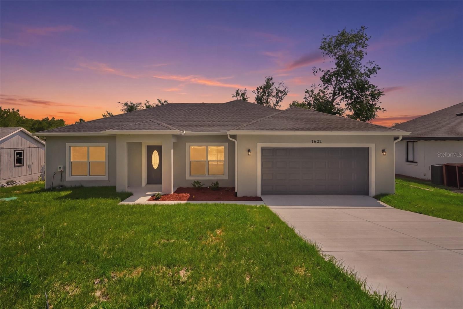 Welcome to this beautifully crafted new construction home in Deltona offering modern finishes, flexible living space, and a functional multi-level layout with no HOA. Conveniently located near Interstate 4, the property provides quick access to Orlando, Sanford, Daytona Beach, shopping, dining, and major Central Florida destinations. Inside, the home features luxury vinyl flooring throughout, recessed lighting throughout the home, and ceiling fans in the bedrooms for added comfort. The open-concept upper level creates a bright and inviting atmosphere with soaring ceilings, modern finishes, and abundant natural light. The kitchen is designed for both style and functionality featuring white shaker cabinetry, granite countertops, stainless steel appliances, a large center island, pendant lighting, and plenty of cabinet space. The spacious main living area features vaulted ceilings peaking at approximately 11.9 feet, adding to the open feel of the home. The primary suite offers generous space, a walk-in closet, and a spacious bathroom layout, while the downstairs level provides additional flexibility with multiple bedrooms, a kitchenette/efficiency area, and a convenient half bath downstairs with direct access to the covered lanai, making it ideal for guests, extended family, or multi-generational living. Outdoor features include an elevated balcony, covered downstairs lanai, and an oversized two-car garage. The home is conveniently located near Publix Super Market, restaurants, parks, medical facilities, and everyday conveniences. This property combines modern construction, stylish finishes, flexible living arrangements, and a prime Deltona location with convenient commuter access and nearby shopping.