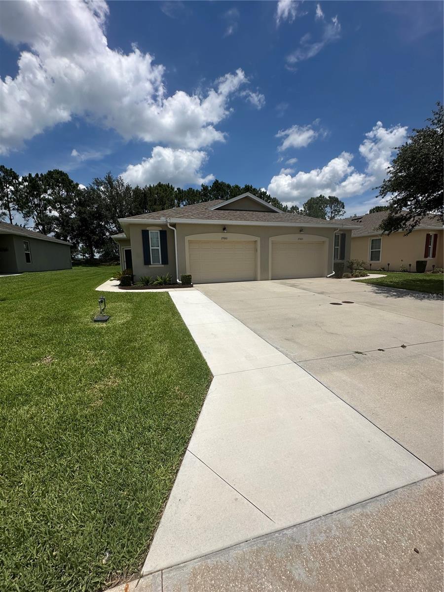 Experience refined Florida living in this beautifully upgraded, maintenance-free villa located in the award-winning Arlington Ridge 55+ golf community. Built in 2018, this 2-bedroom residence offers an open, airy layout with an additional flex room ideal for an office or den. The gourmet kitchen features upgraded soft-close cabinetry, intricate granite countertops, upgraded appliances, a walk-in pantry, and a breakfast bar.
The spacious primary suite includes walk-in and dual closets and an elegant en-suite bath with matching upgraded cabinetry and granite. Luxury carpeting in the bedrooms bring a plush sense of comfort.
An oversized one-car garage with golf-cart parking, storage cabinetry, workshop space, and epoxy flooring adds exceptional functionality. There is an extended back patio with birdcage, no rear neighbors and an oversize lot so there is extra space between neighbors. Also includes Kinetico water softener system and a security storm at the front door.  Enjoy peaceful outdoor living on the extended screened patio overlooking an oversized lot with no rear neighbors.
Residents enjoy resort-style amenities including a Gary Koch–designed golf course, two pools, tennis and pickleball courts, fitness center, restaurant and pub, movie theater, library, and more. The low-maintenance lifestyle is enhanced by HOA services covering exterior painting, roofing, lawn and plant care, landscaping, irrigation, high-speed fiber-optic internet, and cable TV.
Ideally located near shopping, dining, medical facilities, the Florida Turnpike, Harris Lake boat ramp, and just 45 minutes to Orlando attractions and airport. A blend of comfort, convenience, and leisure awaits in one of Central Florida’s premier active-adult communities.