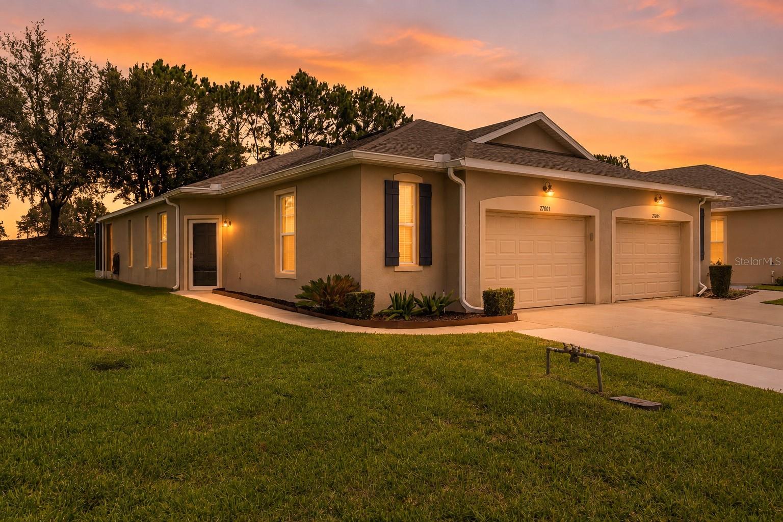 Experience refined Florida living in this beautifully upgraded, maintenance-free villa located in the award-winning Arlington Ridge 55+ golf community. Built in 2018, this 2-bedroom residence offers an open, airy layout with an additional flex room ideal for an office or den. The gourmet kitchen features upgraded soft-close cabinetry, intricate granite countertops, upgraded appliances, a walk-in pantry, and a breakfast bar.
The spacious primary suite includes a walk-in closet and an elegant en-suite bath with matching upgraded cabinetry and granite. Luxury carpeting in the bedrooms bring a plush sense of comfort.
An extended guest-friendly driveway welcomes you to an oversized one-car garage thoughtfully designed with golf-cart parking, custom storage cabinetry, a versatile workshop space, and sleek epoxy flooring that enhances both utility and style. There is an extended back patio with birdcage, no rear neighbors and an oversize lot so there is extra space between neighbors. Also includes Kinetico water softener system and a security storm at the front door.  Enjoy peaceful outdoor living on the extended screened patio overlooking an oversized lot with no rear neighbors.
Residents enjoy resort-style amenities including a Gary Koch–designed golf course, two pools, tennis and pickleball courts, fitness center, restaurant and pub, movie theater, library, and more. The low-maintenance lifestyle is enhanced by HOA services covering exterior painting, roofing, lawn and plant care, landscaping, irrigation, high-speed fiber-optic internet, and cable TV.
Ideally located near shopping, dining, medical facilities, the Florida Turnpike, Harris Lake boat ramp, and just 45 minutes to Orlando attractions and airport. A blend of comfort, convenience, and leisure awaits in one of Central Florida’s premier active-adult communities.