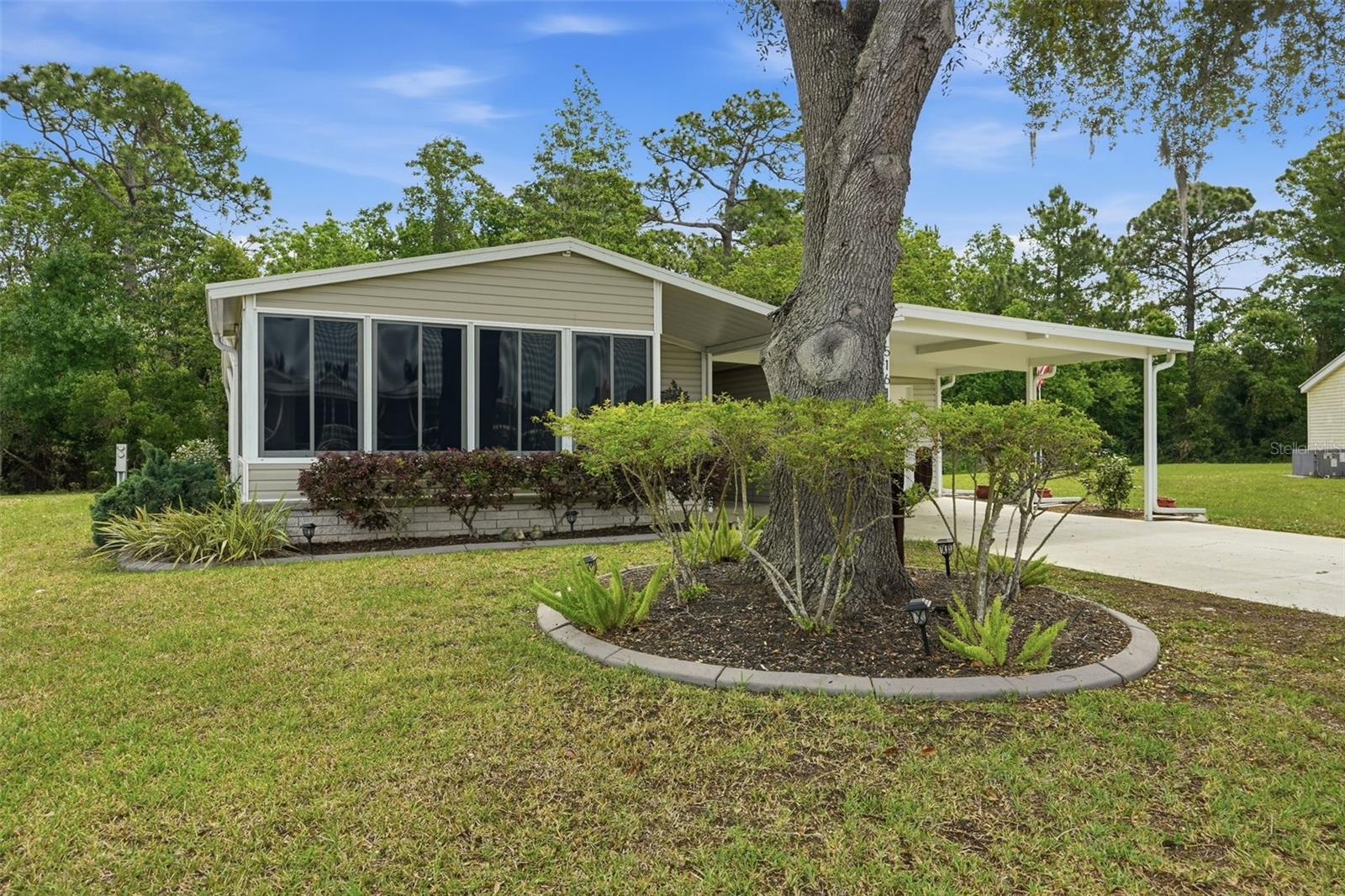 Pride of ownership shines throughout this beautifully maintained home, inside and out! Enjoy the benefit of no lot rent, with lawn maintenance included in the HOA fee.
Situated on a spacious lot with no rear neighbors, this property offers mature trees, added privacy, and plenty of room for gardening or simply enjoying the outdoors.
Inside, you’ll find an immaculately kept 2-bedroom, 2-bathroom home featuring an open floor plan, no carpet, ceiling fans throughout, and convenient indoor laundry.
The kitchen offers ample cabinet space and a breakfast bar, perfect for casual dining or entertaining. The main bathroom features an updated vanity with a tub/shower combo, while the primary suite includes dual vanities and a walk-in shower for added comfort.
Relax on 3 seasons room, perfect for morning coffee or unwinding with a good book.  Out back, a beautiful patio provides the ideal space for entertaining or watching the local wildlife that frequents the area.
Additional highlights include a garage and carport, offering ample storage and parking options. Major updates provide peace of mind, including a roof (2015), HVAC (2013), and an newer hot water heater. The appliances have also been updated, adding to the home’s overall value and functionality.
Located in the desirable Forest Glenn co-op community, residents enjoy a vibrant lifestyle with numerous activities, including bingo, potlucks, social club events, billiards, crafts, and more.  Community amenities include a clubhouse, heated pool, shuffleboard courts, boat and camper storage, trash service, and paved streets.
Conveniently located directly across from the preserve and just under 1.5 miles to Walmart, Publix, and Walgreens, with Hernando Beach dining less than 5 miles away and approximately 1 mile to the Gulf of Mexico.
This is a wonderful opportunity to enjoy comfort, convenience, and an active community lifestyle!