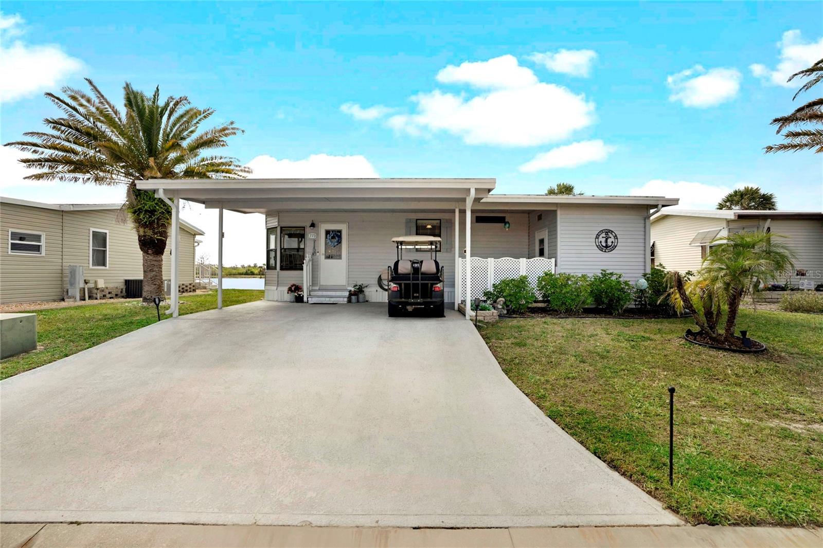 PRICE REDUCED! Beautifully FURNISHED LAKEFRONT 2-bedroom, 2-bathroom home in 55+ Harbor Cove with GULF ACCESS along the Myakka River. This lovely property is positioned centrally on the lake providing a perfect location for views of spectacular sunsets and daily wildlife activity. You'll feel like you're always on vacation with the gorgeous, newer furnishings and included wall décor. Desirable interior features include skylights, cathedral ceilings, updated lighting and luxury vinyl plank flooring. Be inspired in the beautiful kitchen equipped with stainless steel appliances, solid surface countertops and lots of cabinetry. The adjacent dining space is surrounded by windows for an abundance of natural light. Open the French doors in the living room to enjoy those fantastic views from the comfortable enclosed lanai. Two nice bedrooms and a sofa bed on the lanai will accommodate owners and guests with the primary having an ensuite bathroom and walk in shower. Outside is a backyard patio and a covered front porch/carport leading to the storage shed. This home has been meticulously maintained with updates such as a new water heater, recent vapor barrier installation, exterior paint, refreshed landscaping, roof and insulation in 2019 and A/C system in 2018. Harbor Cove offers an active lifestyle with low HOA fees of just $150/month, which include lawn care, seawall maintenance, a Membership Share and access to an array of amenities. Enjoy using the fitness center, two pools, spa, tennis, pickle ball, shuffleboard, and bocce courts. Boating enthusiasts can take advantage of the unbelievable option to rent a boat slip for just $100/year. Residents also enjoy dances, picnics, billiards, crafting, card games and more in the 17,000 sq. ft. activities center overlooking the large marina. Beaches, restaurants, retail outlets and medical services are all just a short drive away. Don’t miss your chance to own a piece of lakefront serenity in this desirable community! Schedule a showing today!