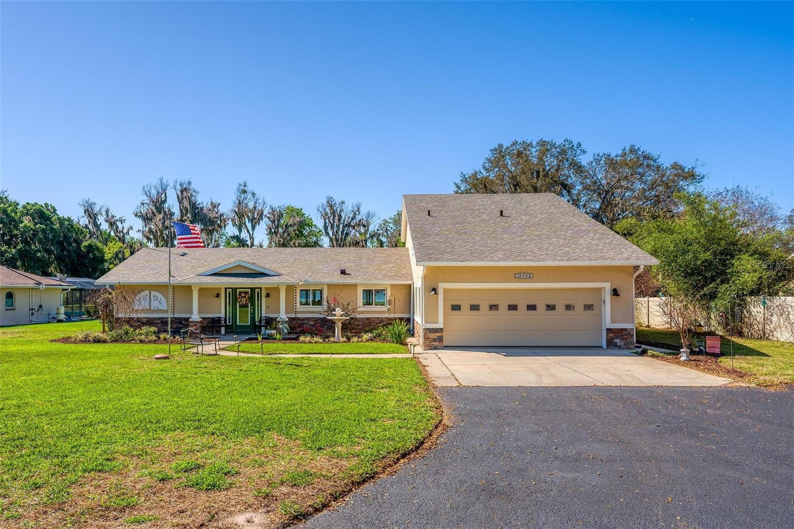 Welcome to 10220 Bumblebee Lane in Leesburg, a truly one-of-a-kind lakefront estate on the legendary Harris Chain of Lakes where luxury, versatility, and lifestyle collide on a sprawling 1.35-acre property with a 164’ dock fully equipped with power, water, lighting, and a mechanical lift setting the tone for unforgettable days and nights on the water before you ever step inside; once you do, the home immediately captivates with breathtaking panoramic views through dual 12’ accordion sliders that open to the pool and lake beyond, showcasing a completely renovated 34’ x 25’ open-concept living, dining, and kitchen space with soaring cathedral ceilings and an entertainer’s dream kitchen featuring an oversized island, farmhouse sink, premium KitchenAid appliances, and even two dishwashers for those lively gatherings, while the thoughtfully designed layout offers three bedrooms downstairs plus a private approximately 725 sq ft upstairs in-law suite with its own exterior and interior entrances, kitchenette, washer/dryer combo, and full bath, perfect for multigenerational living, guests, or income potential, along with a hidden 4’ x 30’ walkable storage corridor cleverly tucked behind the walls; the primary suite delivers a true retreat with French doors to the pool, dual walk-in closets, split granite vanities, a jacuzzi tub, and an accessible walk-in shower, complemented by wide 36” doorways, spacious hallways, accessible bathrooms, and a seamless garage entry all designed for ease and comfort, while outside you’ll also find a dedicated full bath for pool and lake days, a powered 12x12 shed, and a 40’ x 10’ storage container with ventilation, skylight, and industrial storage; the expansive grounds provide ample room for RVs, boats, trailers, future additions, or simply enjoying the privacy and space rarely found on the Chain, with mature landscaping and open skies creating a peaceful retreat just minutes from town, and when it comes to lifestyle, boating from your backyard opens the door to iconic destinations like the scenic Dora Canal, waterfront dining in Tavares at Tiki West Raw Bar & Grill or Ironworks Steakhouse, or an afternoon in charming Mount Dora with stops at The Goblin Market or Pisces Rising for dining and live entertainment, plus convenient access to Orlando, world-renowned attractions, and Florida’s beautiful east and west coast beaches, making this not just a home but a gateway to the ultimate Central Florida lake life—opportunities like this are rare, so if you’ve been dreaming of owning on the Chain, this is your moment.