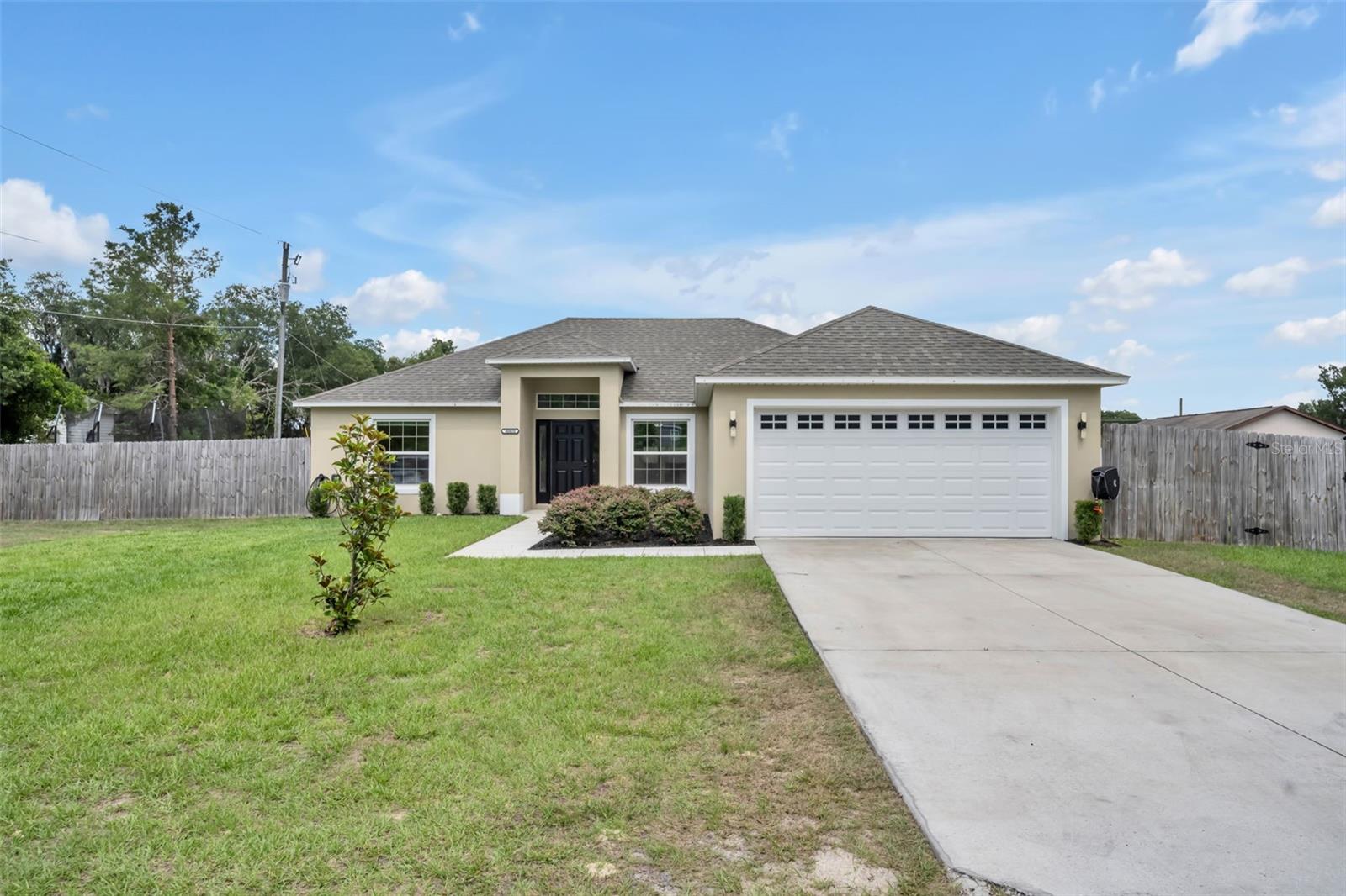 Welcome to this 4-bedroom, 2-bathroom home with an open floor plan, split-bedroom layout, and privacy-fenced backyard. Luxury vinyl plank flooring runs throughout the home, with high ceilings and plenty of closet space. The kitchen opens to the main living area and features granite countertops, shaker cabinets, stainless steel appliances, a breakfast bar, and a closet pantry. The bathrooms include matching shaker cabinets, updated countertops, and tiled tub/shower surrounds. The 4th bedroom is well suited for a home office, flex space, or guest room. Additional features include an indoor laundry room, covered rear porch, and 2-car garage. Located near North Lake Park with a quiet country setting.