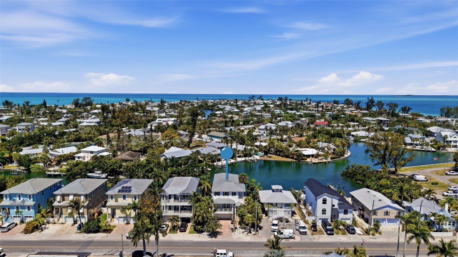Positioned along the most sought-after stretch of Pine Avenue—known for its vibrant coastal charm, boutique shopping, dining, and steady pedestrian traffic, 418 Pine Avenue offers a truly rare opportunity to own a waterfront property with coveted ROR zoning. Properties like this are few and far between, especially those that combine direct water access with the ability to create both a luxury lifestyle and a dynamic income-producing asset in the heart of one of the island’s most iconic corridors.



This elevated, solid concrete home features 4 bedrooms and 3 bathrooms, each bedroom offering spacious walk-in closets complete with custom closet systems. The open-concept floor plan is designed to maximize natural light and water views, seamlessly blending indoor and outdoor living. Step out onto the expansive main-level balcony or enjoy one of three additional balconies—two overlooking the water and two facing the lively energy of Pine Avenue.



The ROR zoning creates exceptional flexibility for income potential. Envision renting the upper-level residence while activating the lower level as a waterfront-facing business such as a boutique retail shop, professional office, art gallery, wellness studio, café, or even a unique waterfront business concept like a paddleboard/kayak outfitter, dockside café, or marine-focused experience. The combination of visibility from Pine Avenue and direct water frontage is incredibly rare and valuable.



Boating enthusiasts will appreciate having only one fixed bridge to open water, along with a private dock where marine life is frequently seen right in your backyard. The outdoor space is equally impressive, featuring a pool and ample room for entertaining, dining, and enjoying the Florida lifestyle year-round.



Additional highlights include impact windows and doors throughout, plantation shutters, newer HVAC system, metal roof, and fresh interior paint. Whether you’re searching for a primary residence, a luxurious second home, or a high-performing investment with unmatched zoning advantages, this property delivers on every level. Being sold complete with professional design services to help you elevate and personalize the space.
