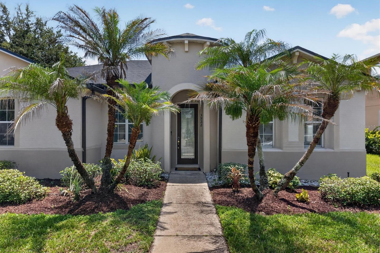 Welcome home to 3922 Cedar Hammock Trail, nestled in the lovely Stevens Plantation community. From the moment you arrive, you will appreciate the home's inviting curb appeal, highlighted by mature landscaping, a welcoming entry, and a side-facing garage that creates an attractive streetscape while providing an extended driveway for additional parking.

Inside, a bright and spacious open floor plan is filled with natural light and offers flexible living spaces designed for both everyday comfort and entertaining. The expansive living area seamlessly connects to the formal dining space and well-appointed kitchen, creating the perfect gathering place for family and friends. The kitchen features 42-inch cherry cabinetry, granite countertops, stainless steel appliances, a breakfast bar ideal for casual conversations while meals are being prepared, and a separate breakfast nook. French doors from the nook lead to the large, fully fenced backyard, offering plenty of room for outdoor entertaining, pets, play, or future garden projects.

The thoughtfully designed split-bedroom floor plan provides privacy for everyone. Two generously sized secondary bedrooms and a full hall bathroom are located just off the entry, while the private primary suite overlooks the backyard through large windows and features a spacious en-suite bathroom and a walk-in closet.

Additional conveniences include an indoor laundry room located just off the garage, creating the perfect drop zone for bags, shoes, and everyday essentials as you enter the home.

Offered as-is for the seller's convenience, this home combines major system updates with the opportunity to add your own finishing touches. With a new roof (2024), HVAC (2023), and fresh interior paint (2025) already completed, simple cosmetic enhancements like updated flooring in the living areas and exterior paint could make this property truly shine.

Residents of Stevens Plantation enjoy peaceful surroundings, tree-lined streets, and community amenities, including swimming pools and recreational areas. Conveniently located just minutes from Florida's Turnpike, commuting is a breeze, while shopping, dining, and everyday conveniences are all within a short drive.

This move-in-ready home combines comfort, functionality, and an ideal location—everything you've been looking for in your next home.
