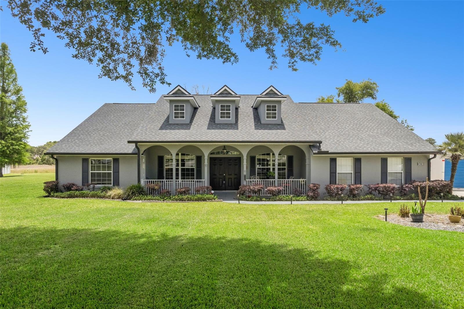 HUGE PRICE REDUCTION!!! This gorgeous home is currently listed UNDER appraised value. Welcome to the highly sought after Grand Oak Estates!!! This spacious 4-bedroom, 2-bath split-plan home offers a well-designed layout with both formal and casual living spaces. Enter through impressive double front doors into a welcoming sitting area, complemented by a formal dining room—perfect for entertaining. The large kitchen features a breakfast nook and opens to a generous living space. The primary suite includes an oversized shower, tub and walk-in closet, while a dedicated laundry room adds convenience. Enjoy outdoor living with a large lanai overlooking an expansive yard on a .72 acre lot, ideal for relaxing or hosting gatherings. Additional features include a 2-car garage and extended driveway for ample parking. Located near Lake Dora in a beautiful neighborhood known for its large lots, this home combines comfort, space, and a prime setting. Pride of ownership shines throughout this one-owner home. Major updates include a roof replacement in 2023 with a transferable warranty, a water softener installed in 2022, a beautifully updated primary bathroom in 2023, and an upgraded kitchen in 2021.