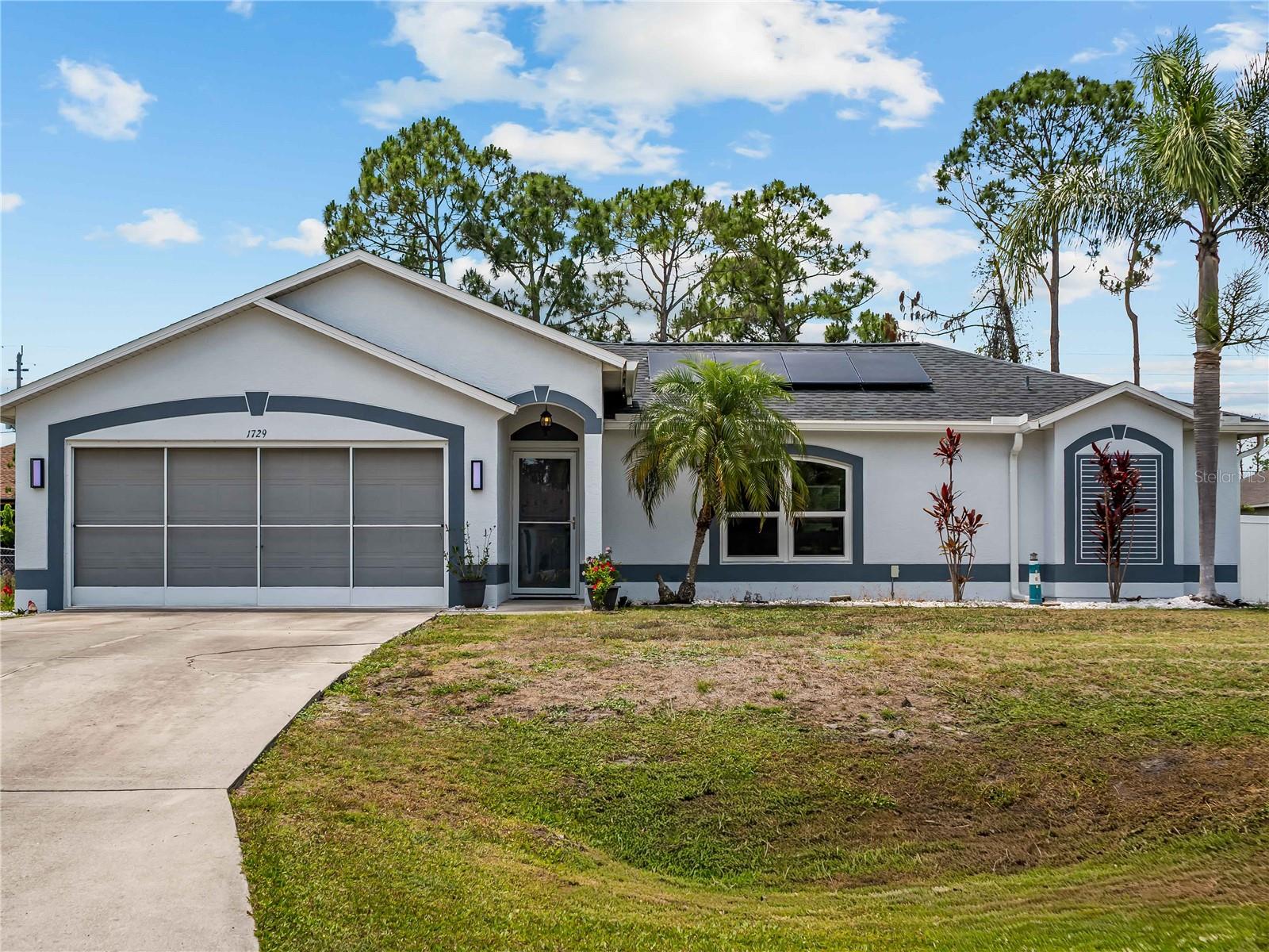 Welcome to 1729 Milan St! Located in the heart of North Port on CITY WATER, this beautifully updated 3-bedroom, 2-bath pool home offers comfort, style, and peace of mind with a long list of recent upgrades. Conveniently situated within a mile of schools, shopping, dining, and everyday conveniences, this meticulously maintained residence is truly move-in ready.

Step inside to discover a spacious open layout highlighted by all-new luxury vinyl plank flooring throughout and an inviting living room filled with natural light. A charming reading nook or flex space just off the main living area can easily serve as a formal dining room, office, or sitting area. The refreshed kitchen features abundant cabinetry, generous counter space, and tasteful 2025 updates that make it both functional and stylish. Adjacent to the kitchen is a large dining/family room area with direct access to the lanai and pool, creating the perfect setup for entertaining.

The split-bedroom floor plan provides privacy and flexibility for family and guests alike. Two generously sized guest bedrooms and a shared bath are located on one side of the home, while the spacious primary suite offers private pool access and a beautifully updated en-suite bath complete with dual vanities.

Outdoor living shines with an oversized screened lanai, expansive pool deck, and a fully fenced backyard featuring durable white vinyl fencing for added privacy. A wired storage shed provides the perfect space for tools, lawn equipment, or a workshop setup.

Major recent upgrades include a new roof (2023), hurricane impact windows (2023), new gutter system, updated overhead plumbing, a 5-year-old A/C system, mini-split A/C in the garage, and a fully paid-off solar system for added energy efficiency and long-term savings. This exceptional property combines modern upgrades, functional living space, and an unbeatable location all in one impressive package.